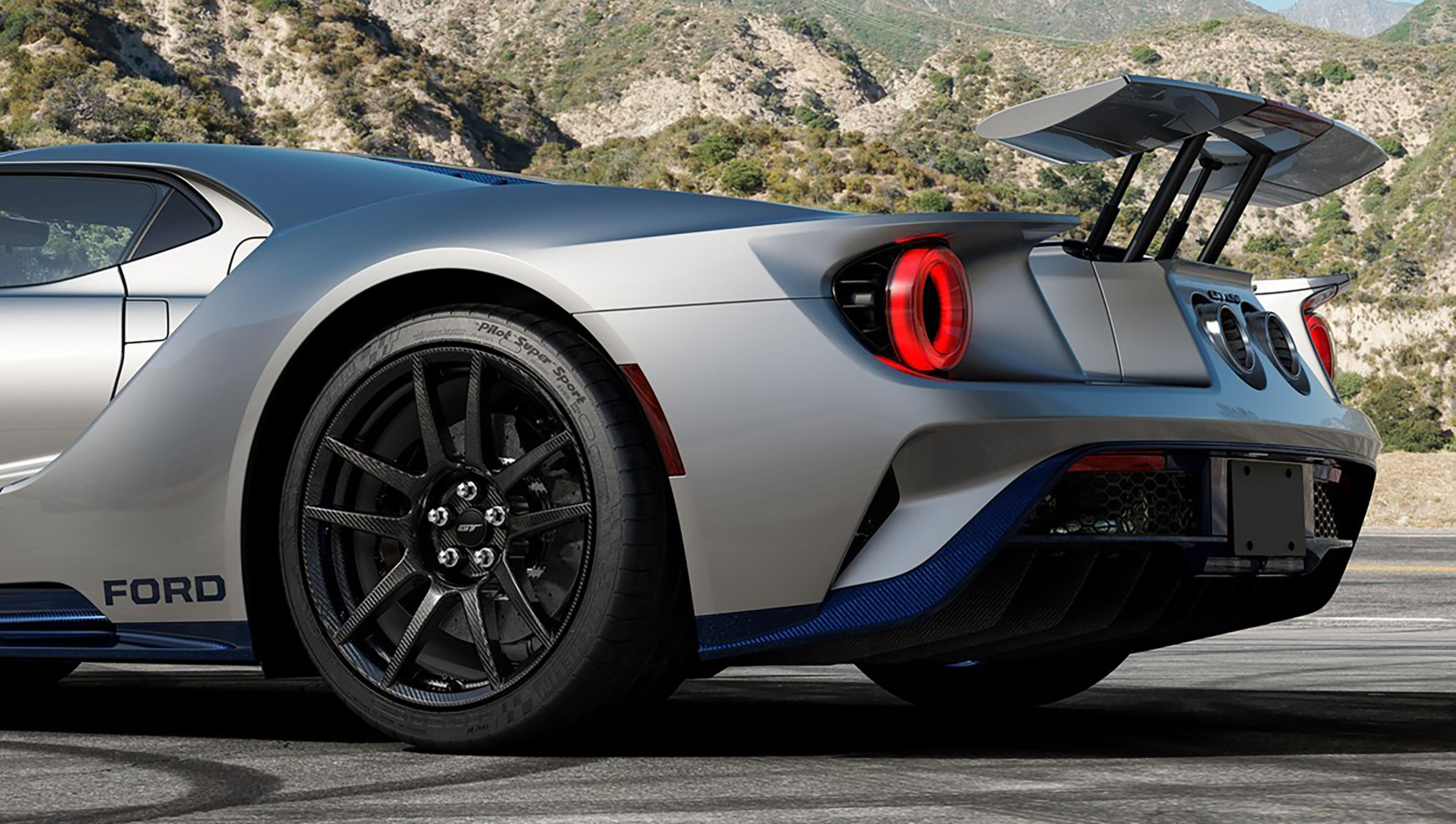 The rear of a silver and blue Ford GT Mk II