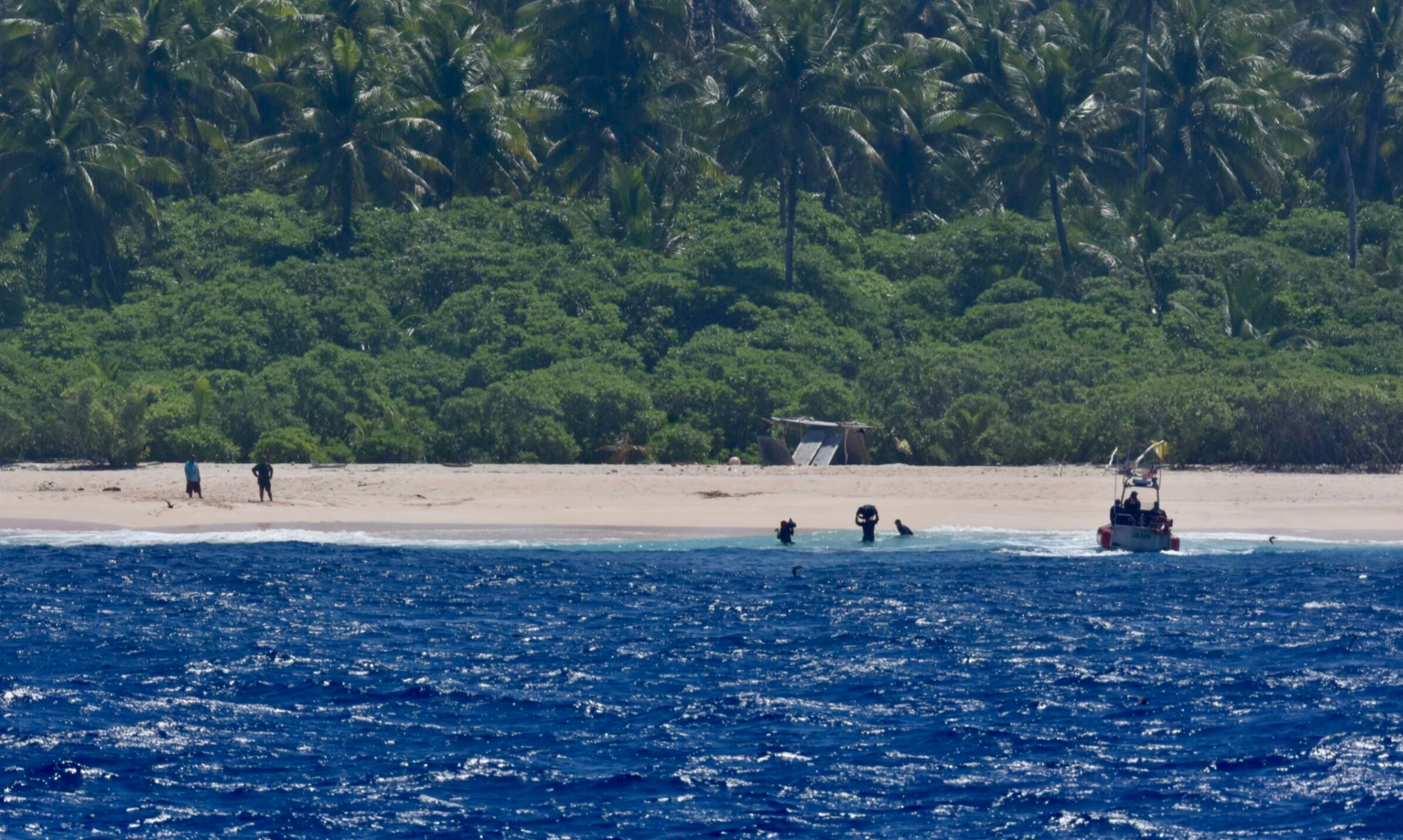 The crew of USCGC Oliver Henry (WPC 1140) helps transfer the belongings of three mariners stranded on Pikelot Atoll, Yap State, Federated States of Micronesia, on April 9, 2024.