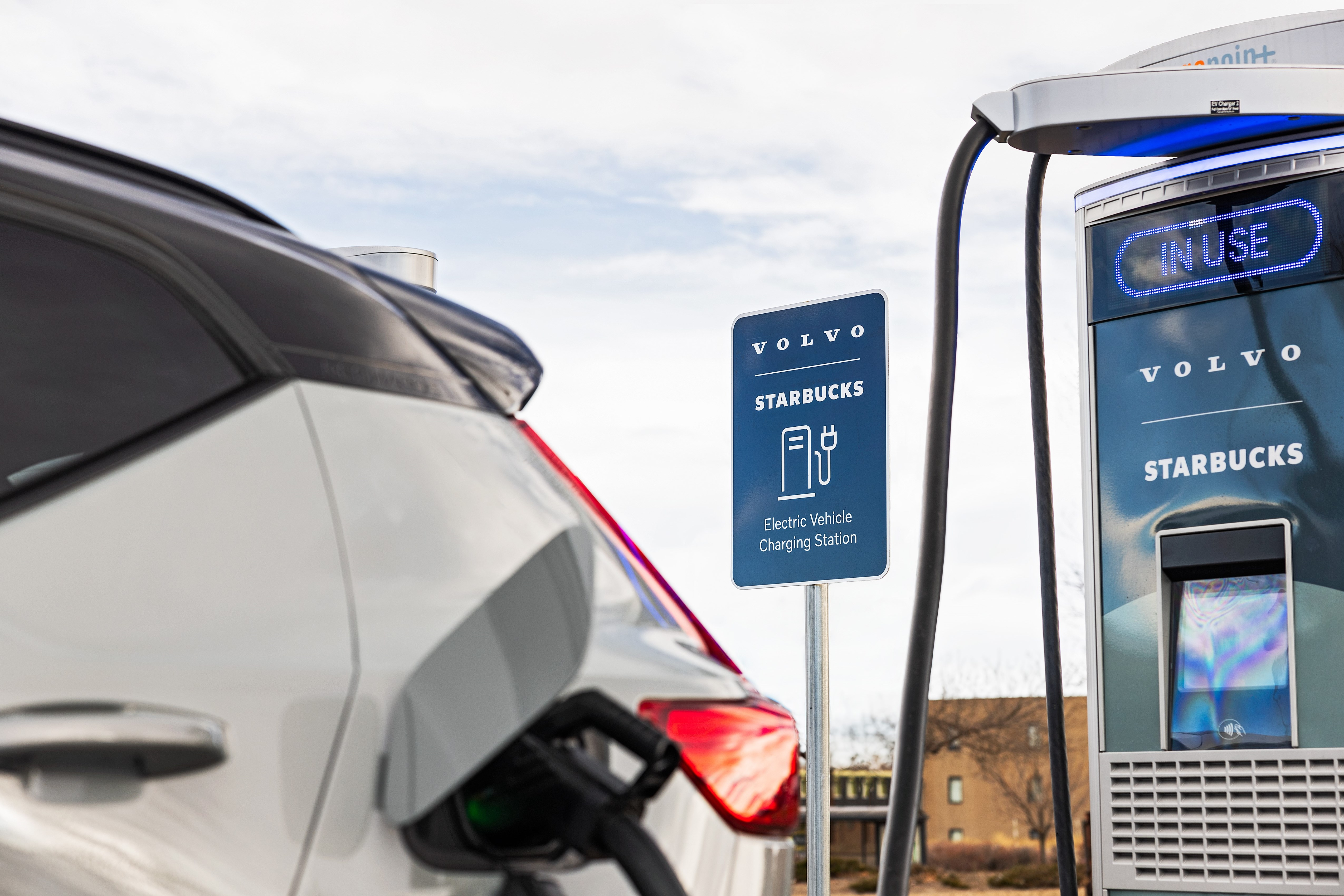 A Volvo XC40 plugged into a Starbucks charging station