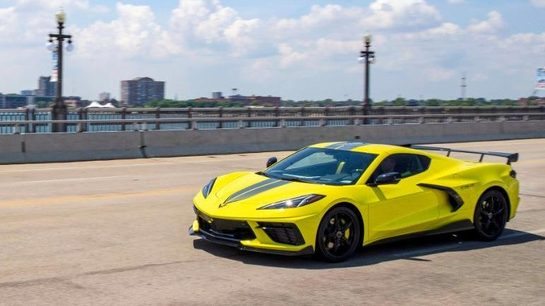 A yellow 2021 corvette sting ray with special edition C8.R Championship decals, photographed on the bridge leading to belle isle in detroit.