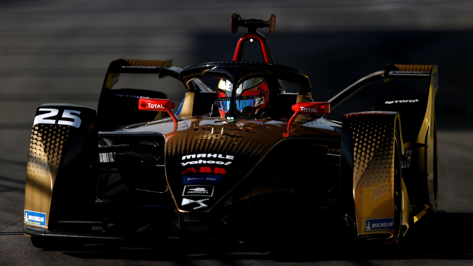 A DS Techeetah Formula E car races round a track. 