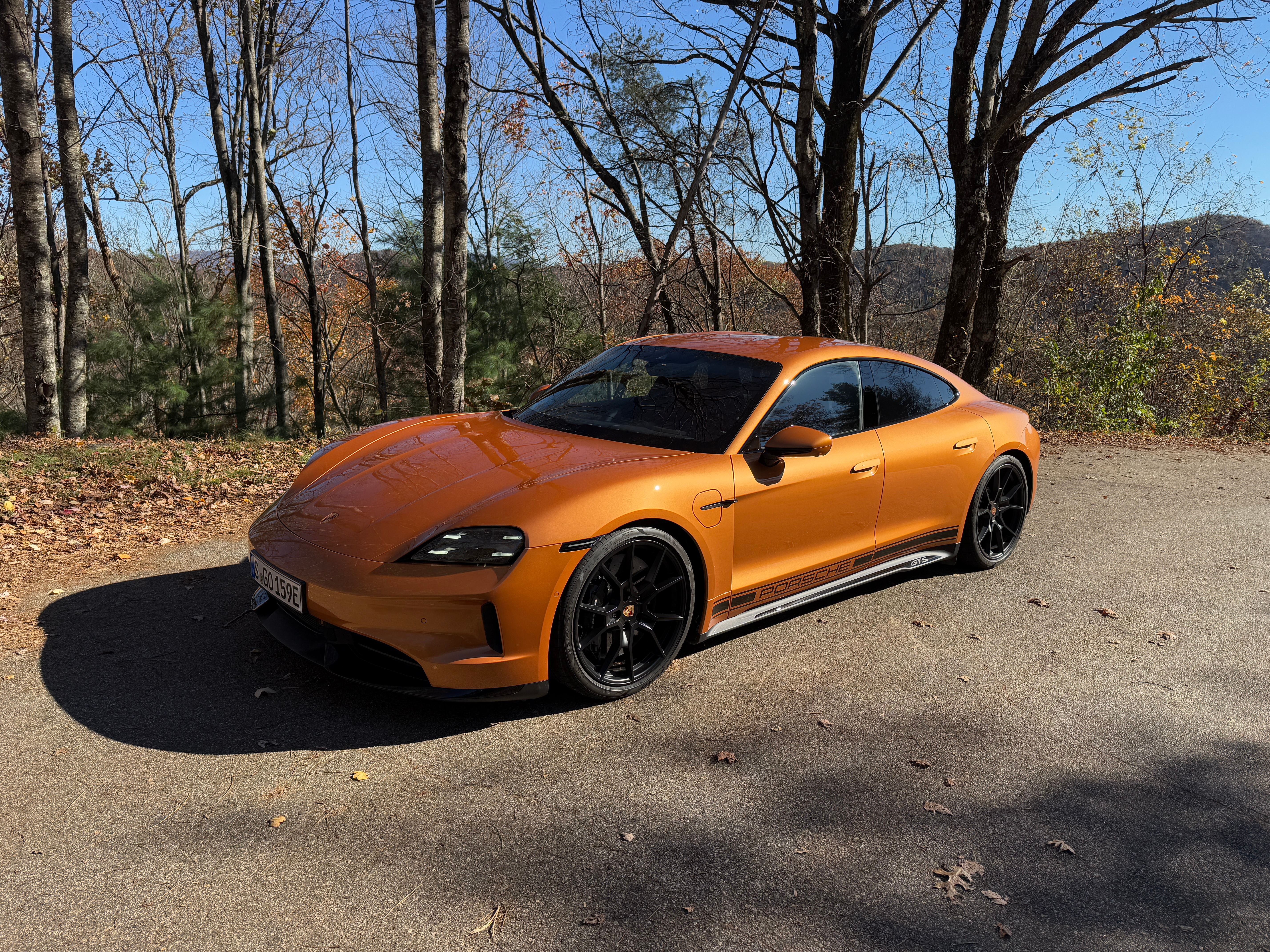 Front 3/4 view of a Nordic Gold 2025 Porsche Taycan GTS sedan