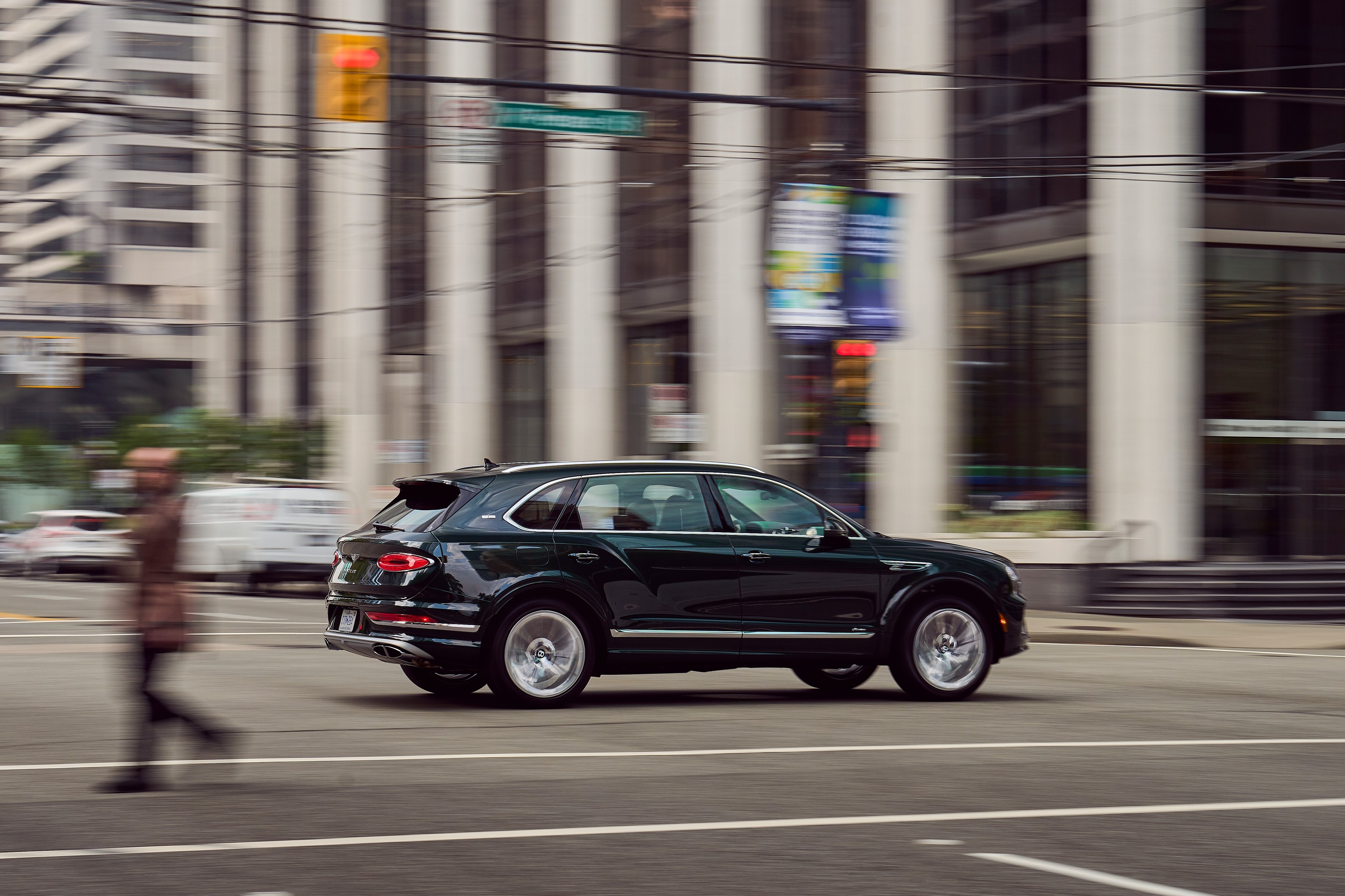 A Bentley SUV drives through an intersection.