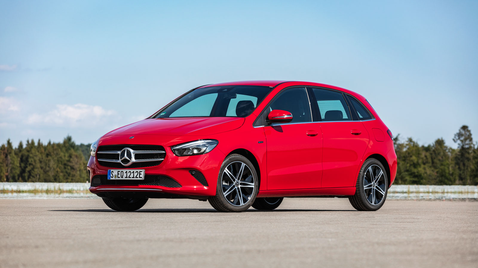 A photo of a red Mercedes B Class hatchback in a parking lot. 