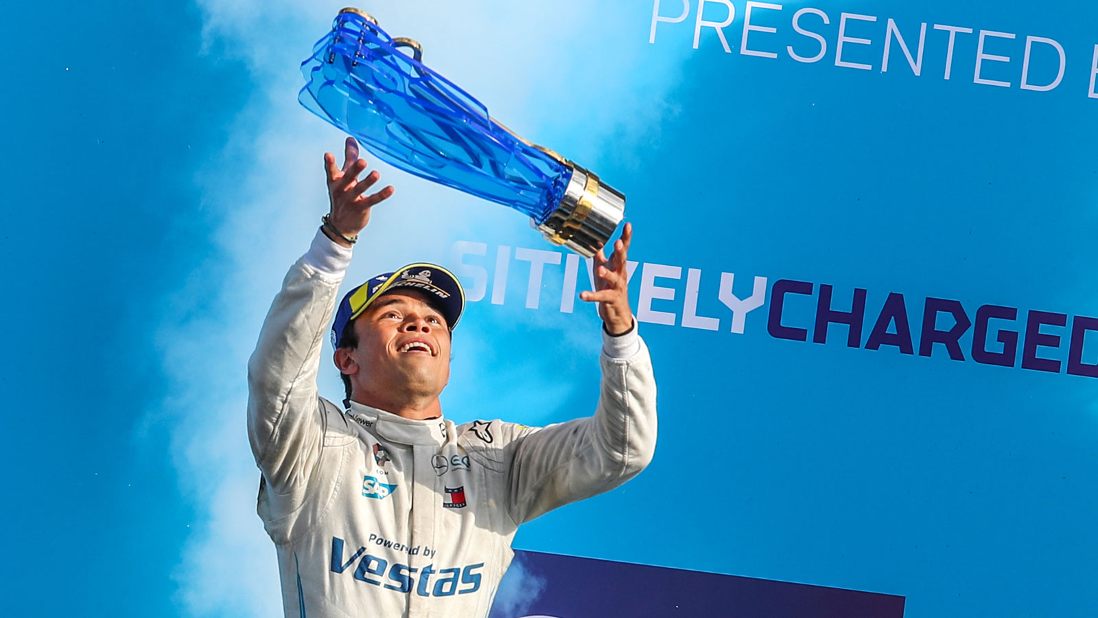 A photo of Nyck De Vries holding the Formula E trophy. 