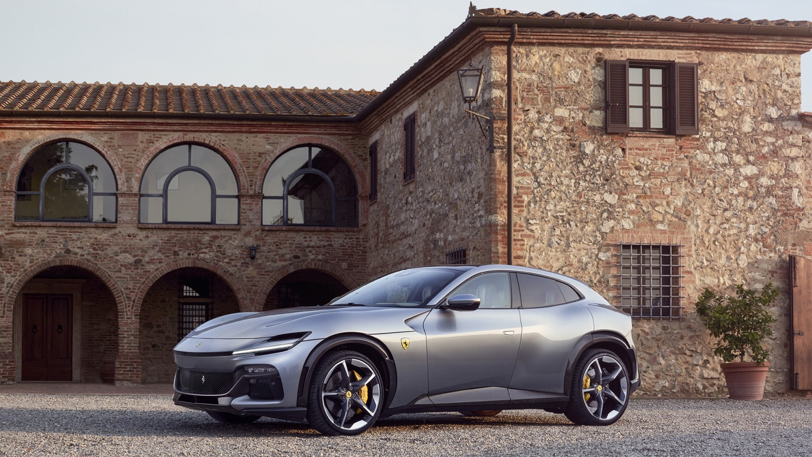 A photo of a silver Ferrari Purosangue SUV. 