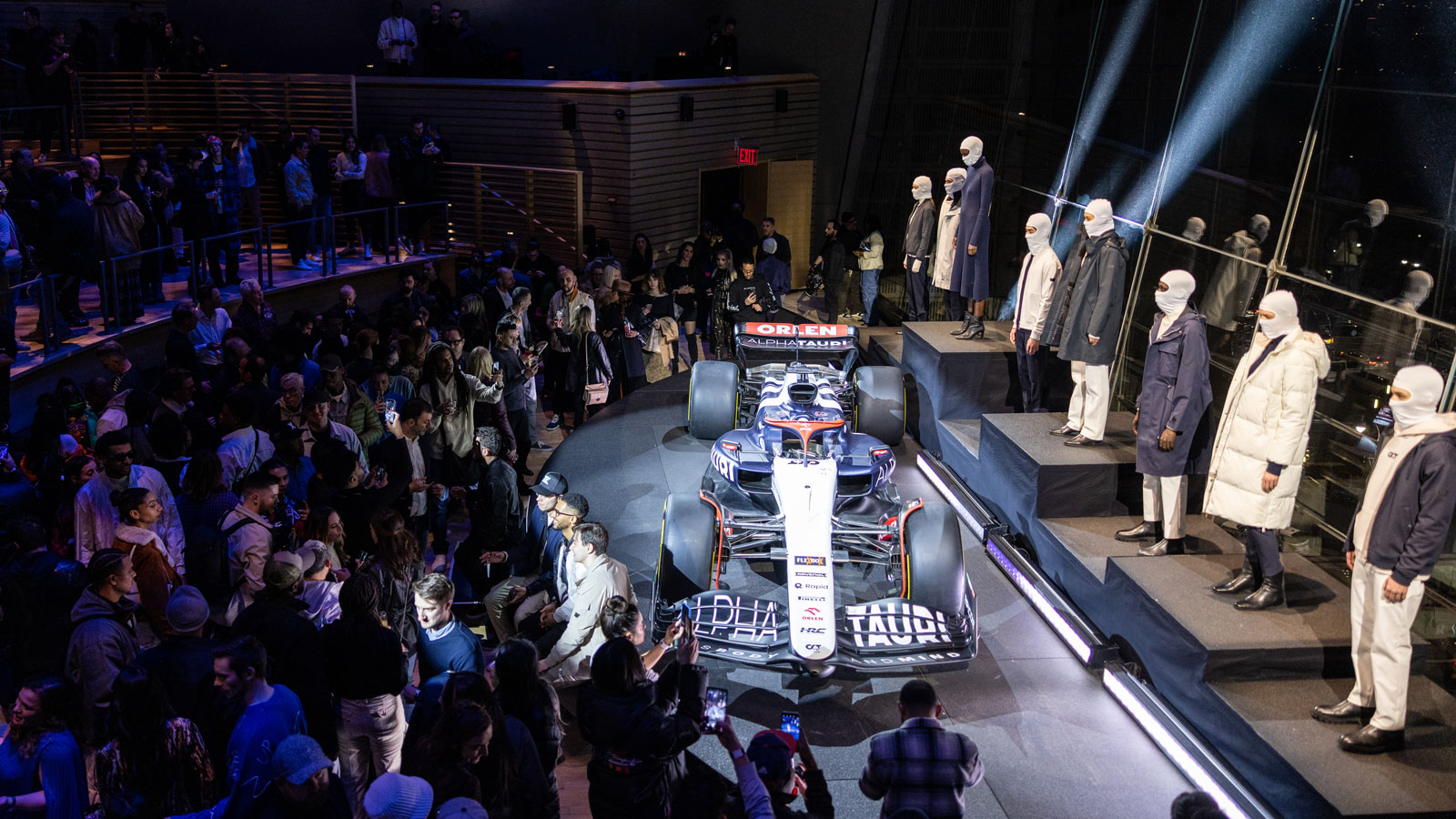 A photo of the AlphaTauri F1 car at the center of an event in New York. 