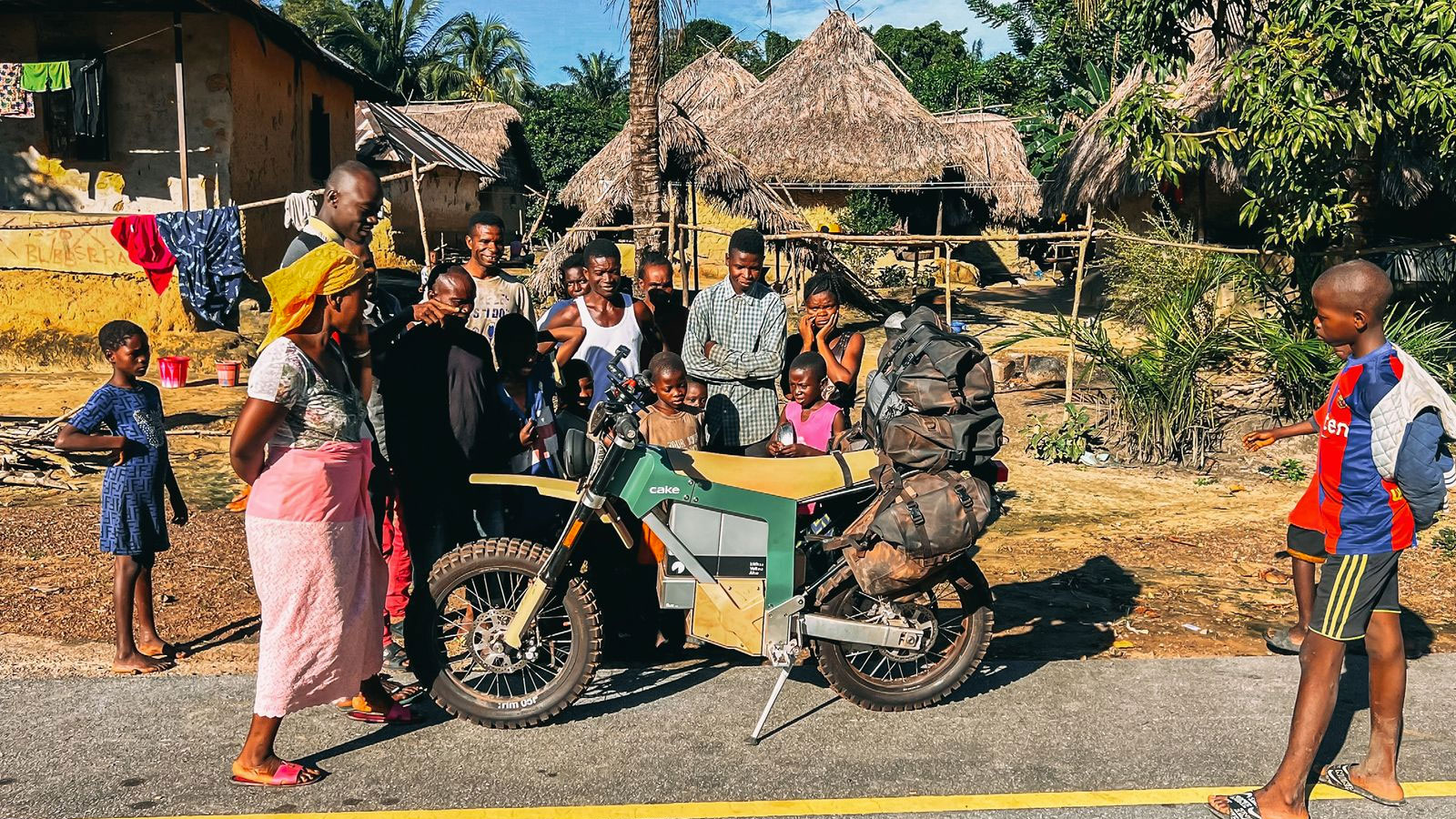 A photo of a green Cake bike parked by the side of the road. 