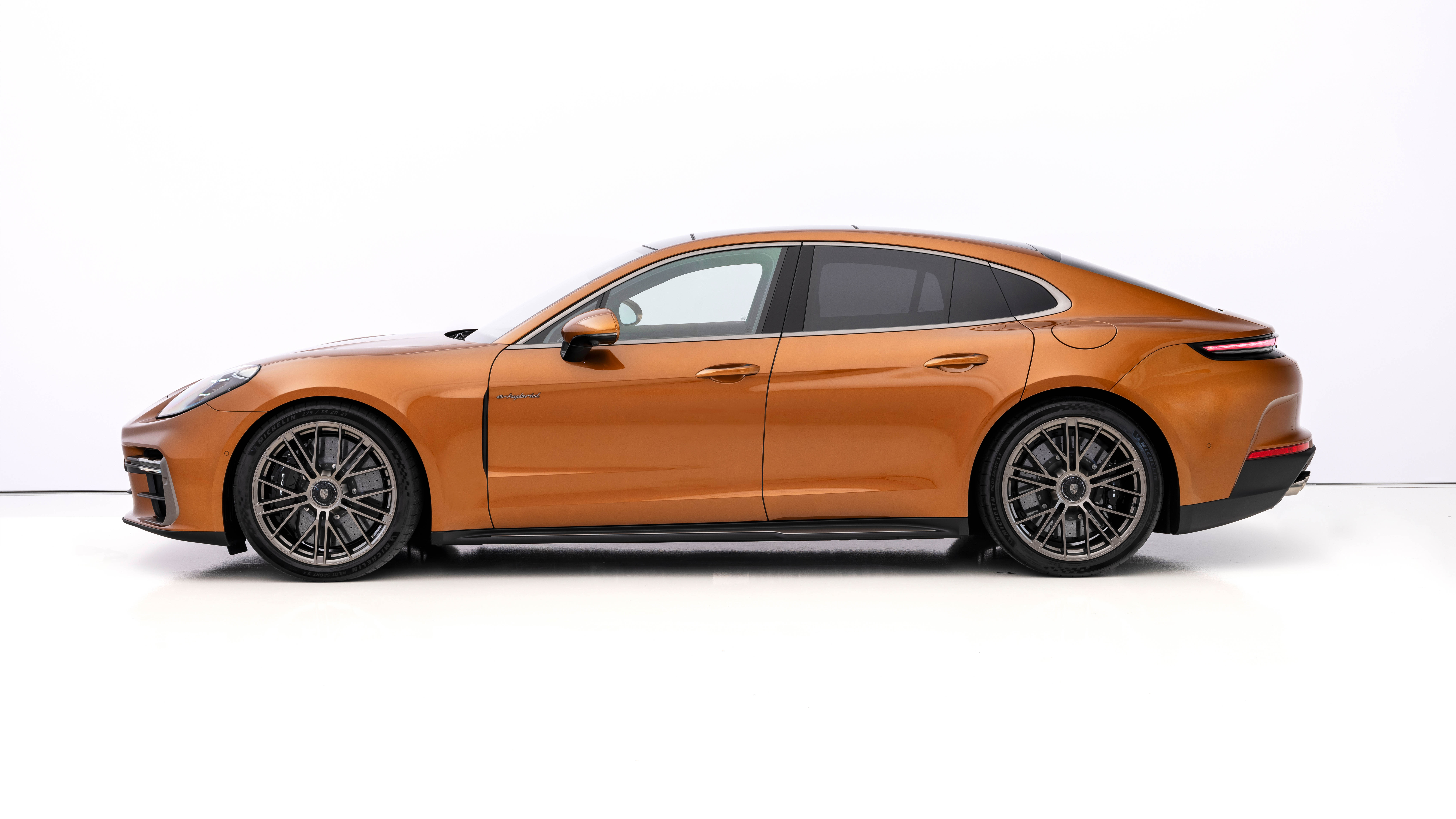 Side view of an orange 2024 Porsche Panamera