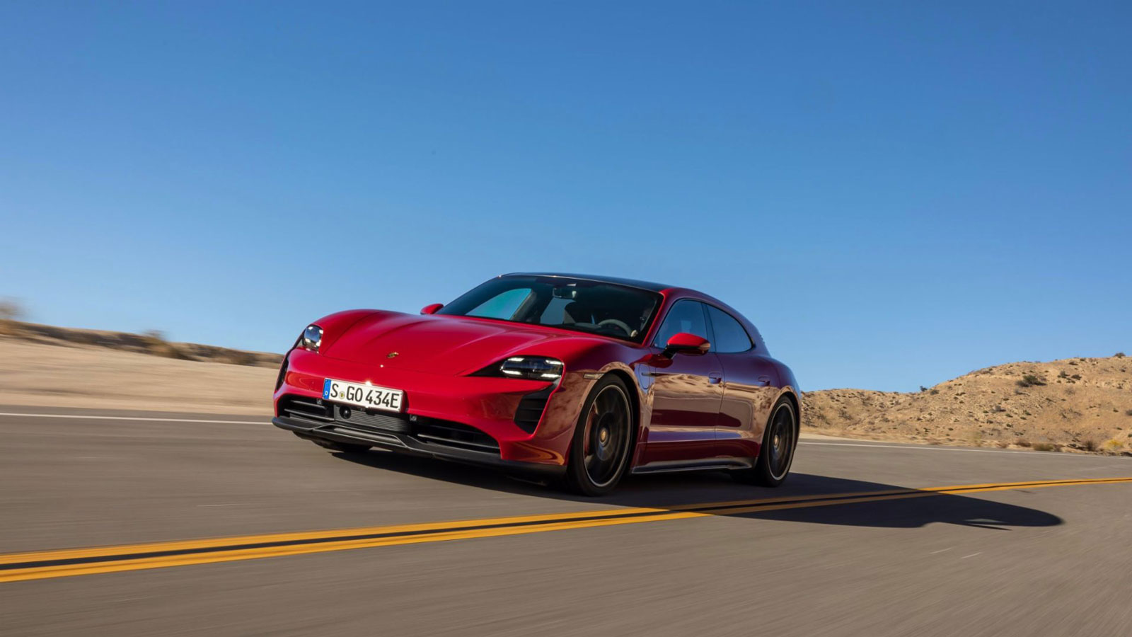 A photo of a red Porsche Taycan electric sports car. 