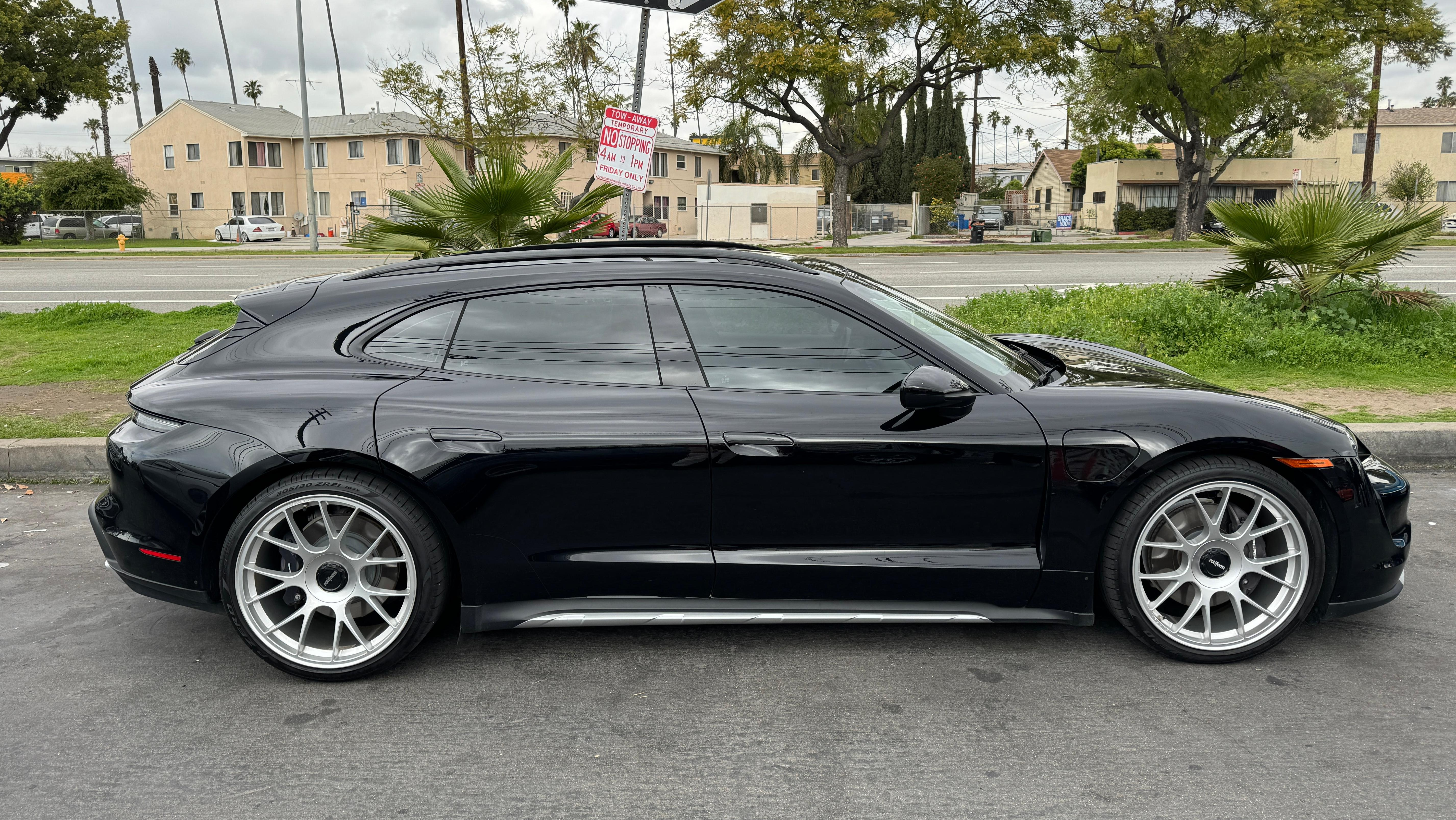 Side view of a black Porsche Taycan Cross Turismo