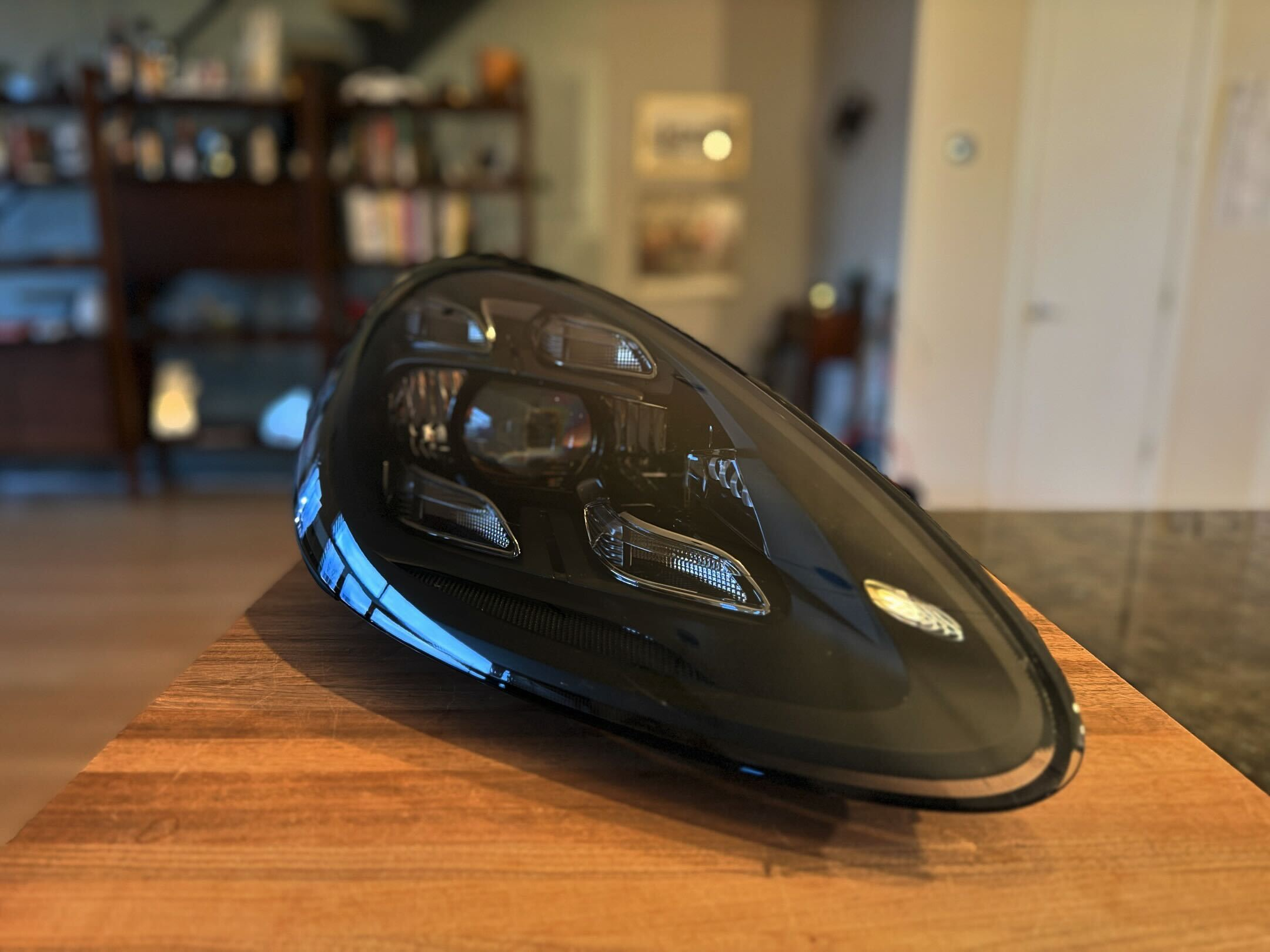 Lightwerkz headlamp for 2013 Porsche Cayenne Diesel sitting on a kitchen counter