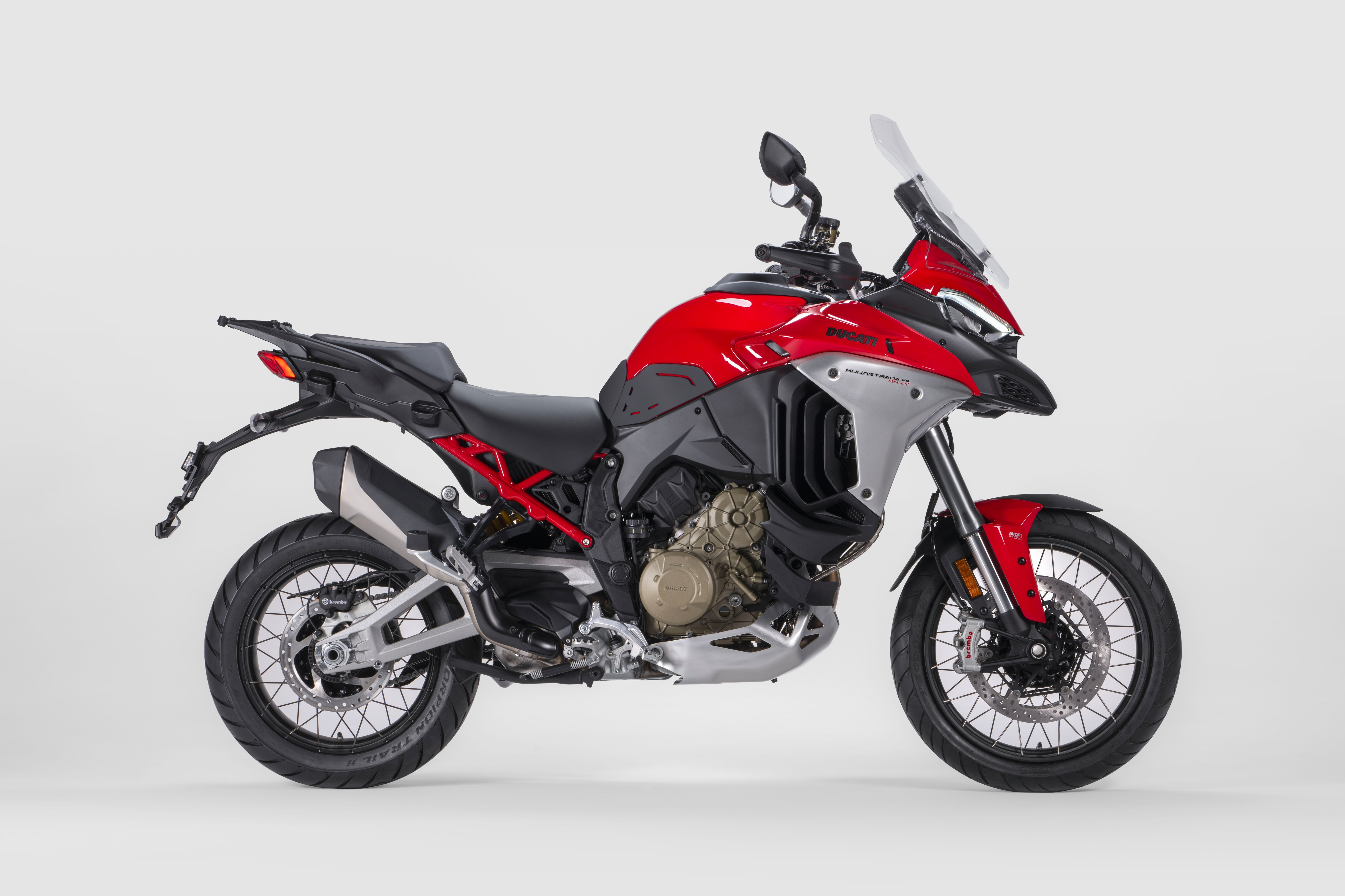 Side view of a Ducati Multistrada V4 Rally in front of a white background.