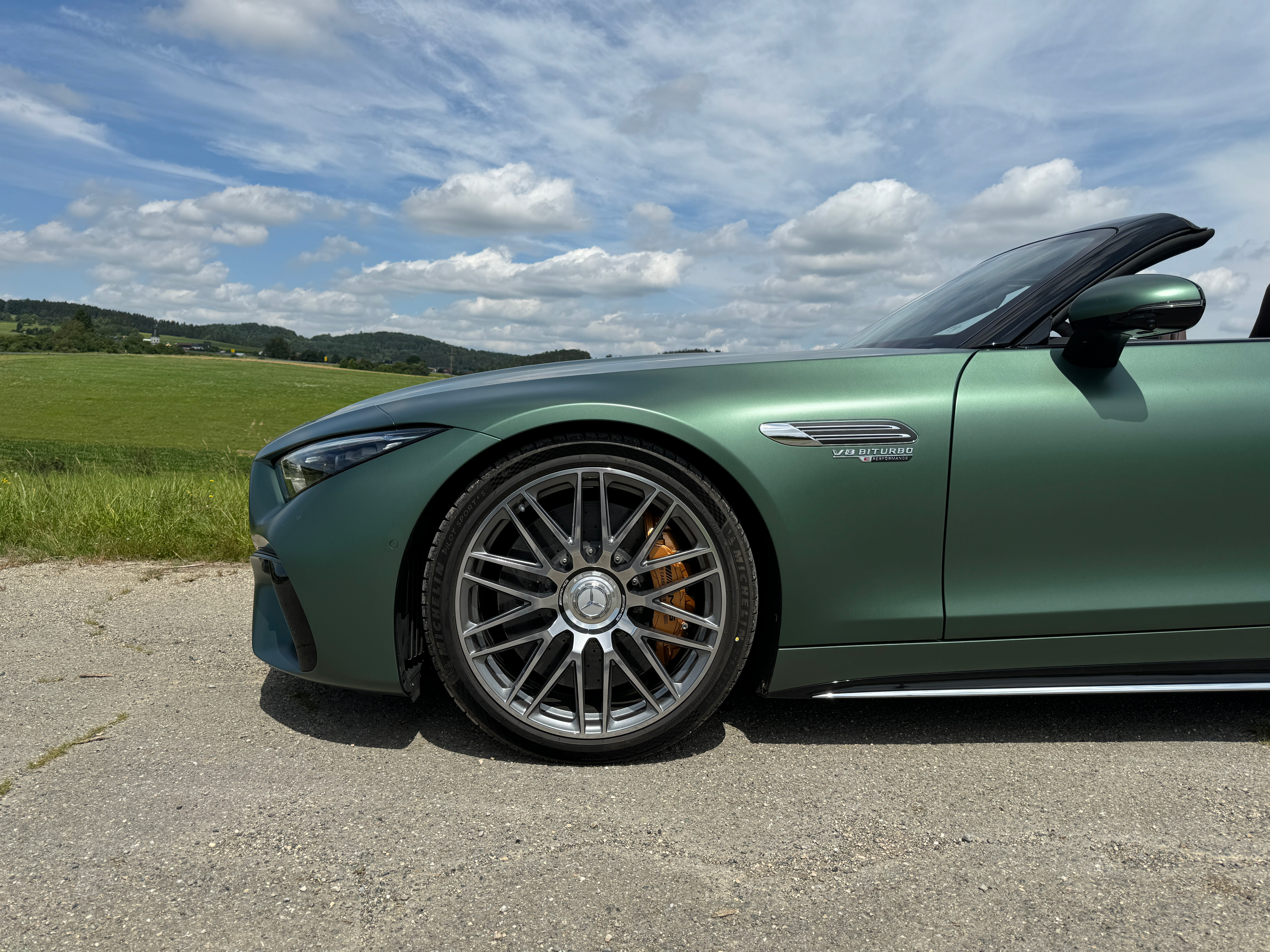 Front wheel of a matte green Mercedes-AMG SL63 S E Performance