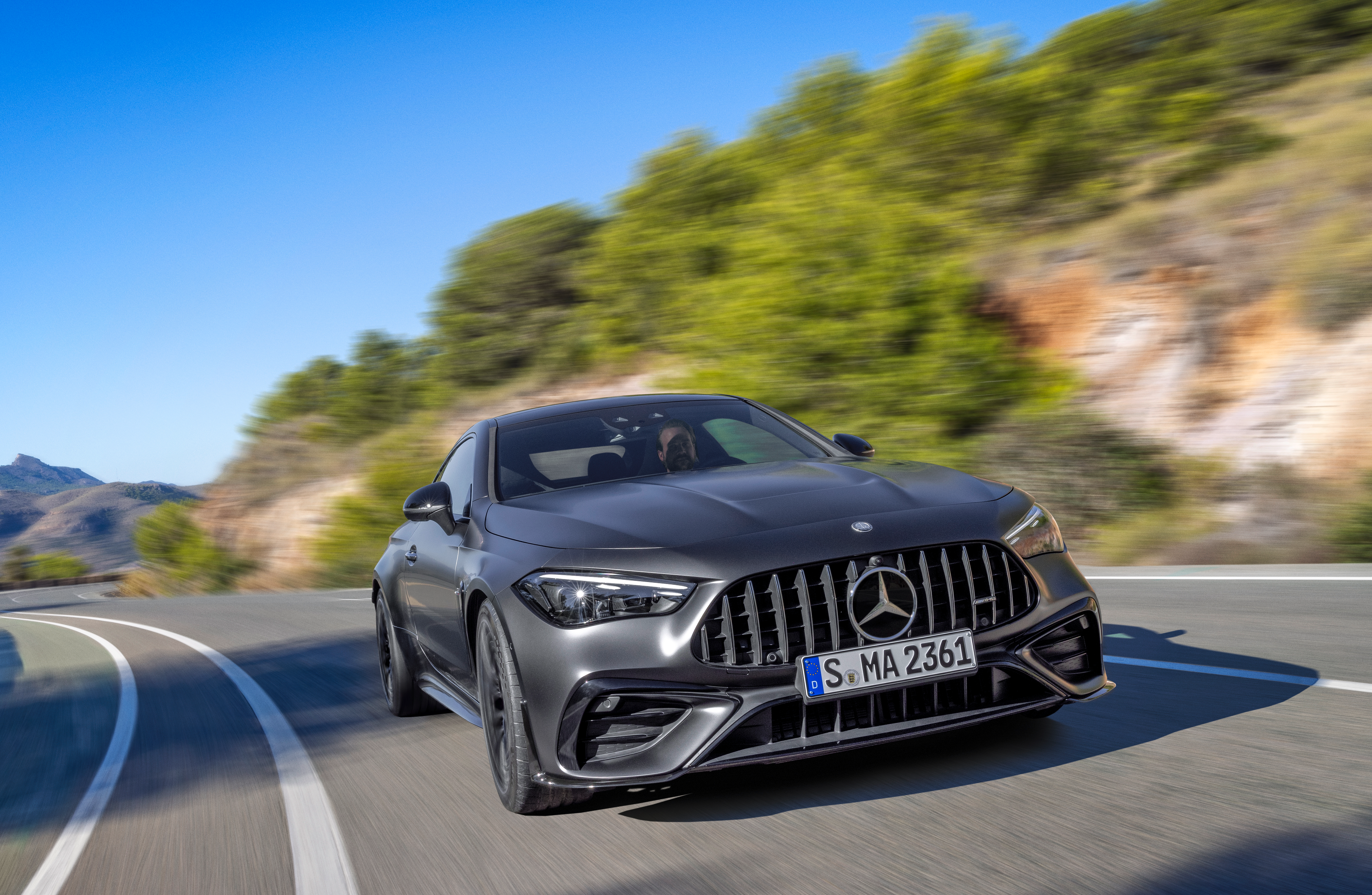 Front view of a matte black Mercedes-AMG CLE53 coupe driving