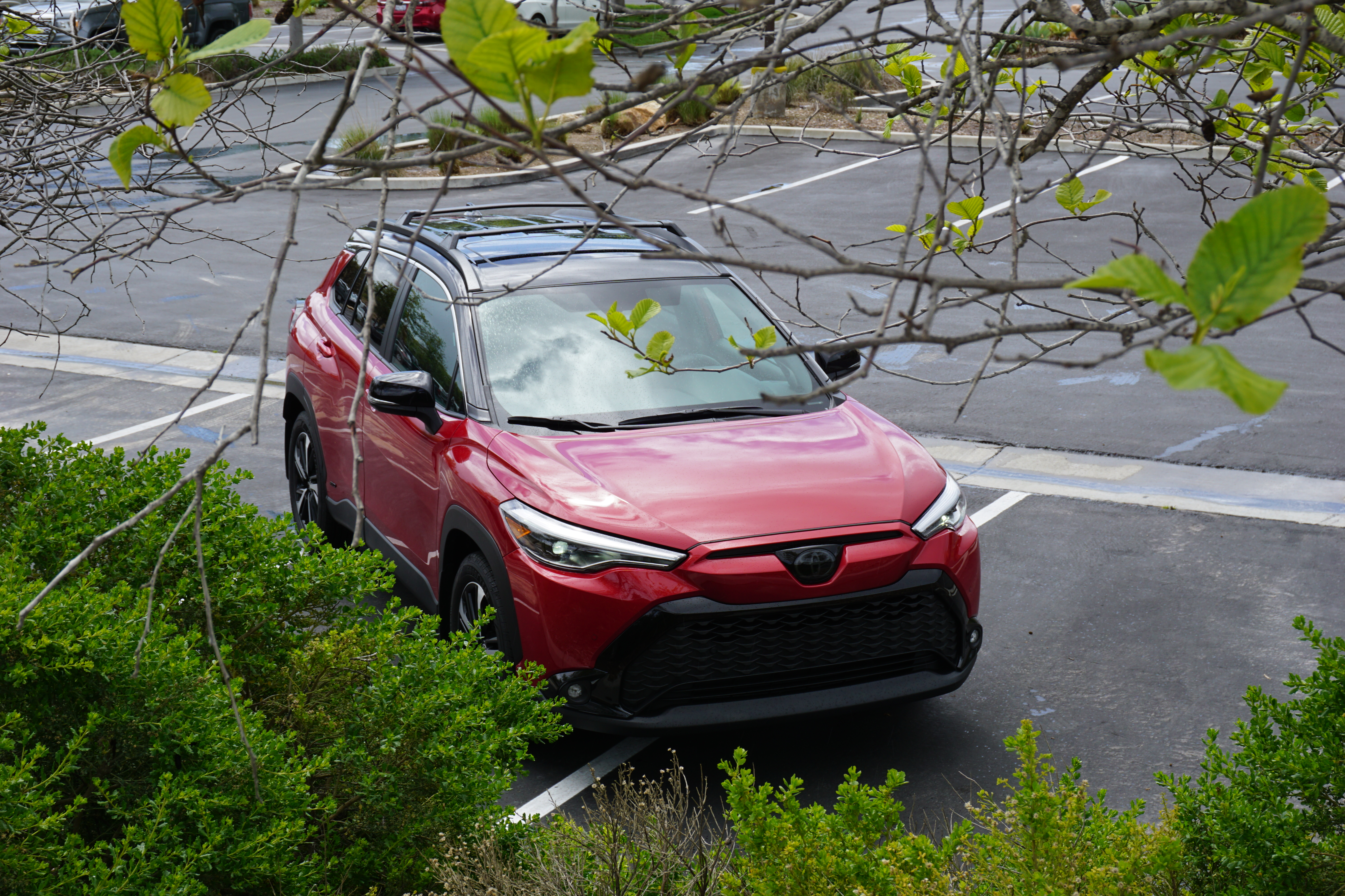 A red 2023 Toyota Corolla Cross Hybrid.