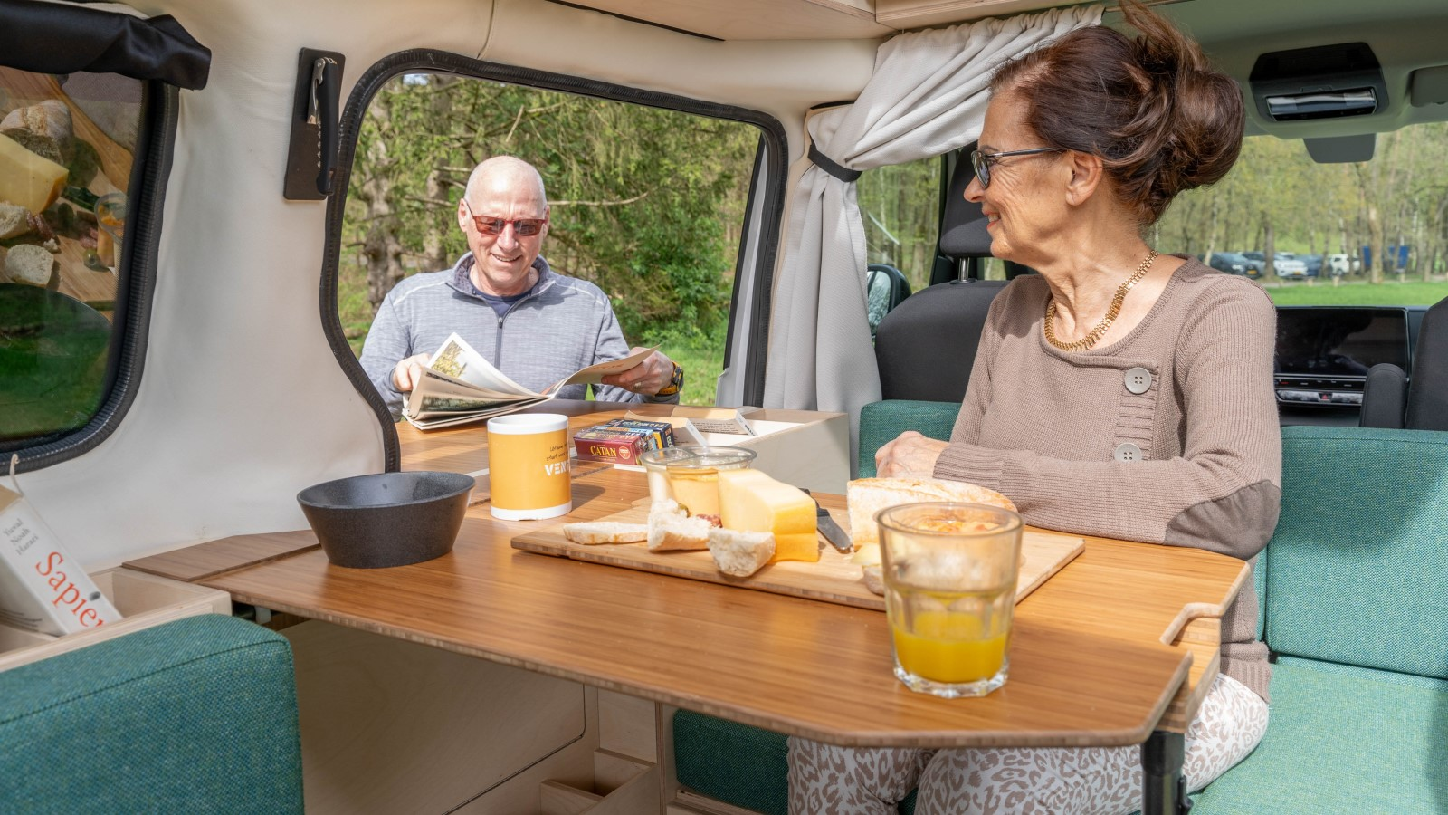 A photo of someone sitting in an electric camper. 