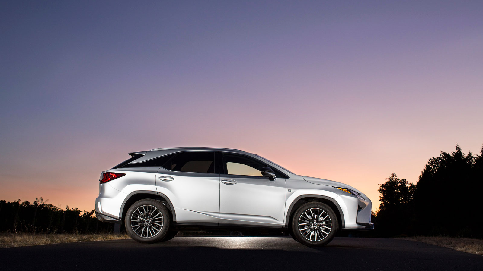 A photo of a Lexus RX SUV at sunset. 