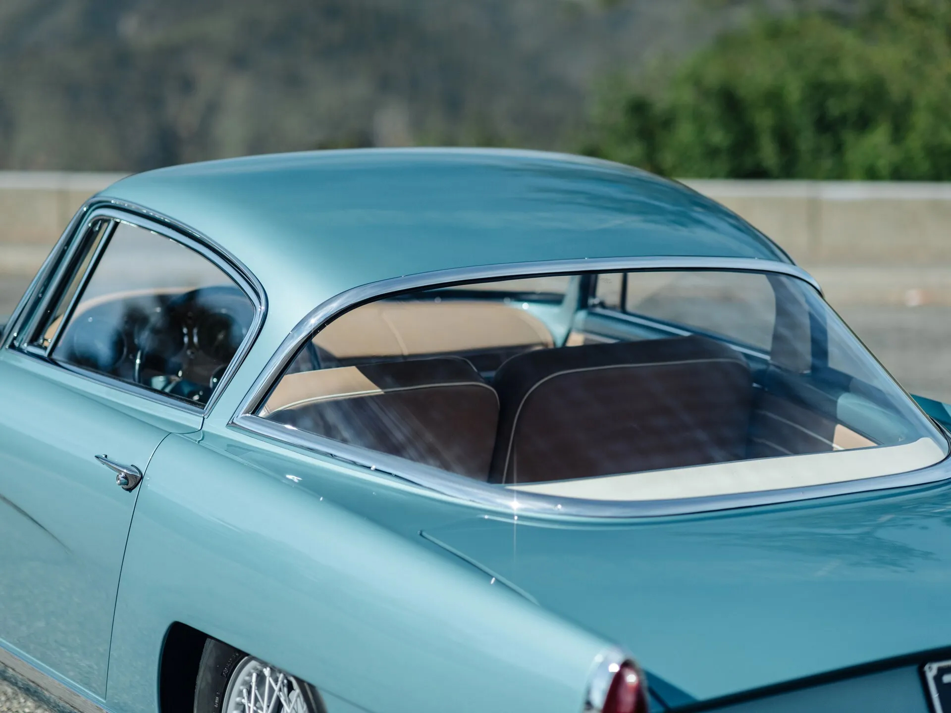 Rear window of a teal Aston Martin DB2/4 by Bertone