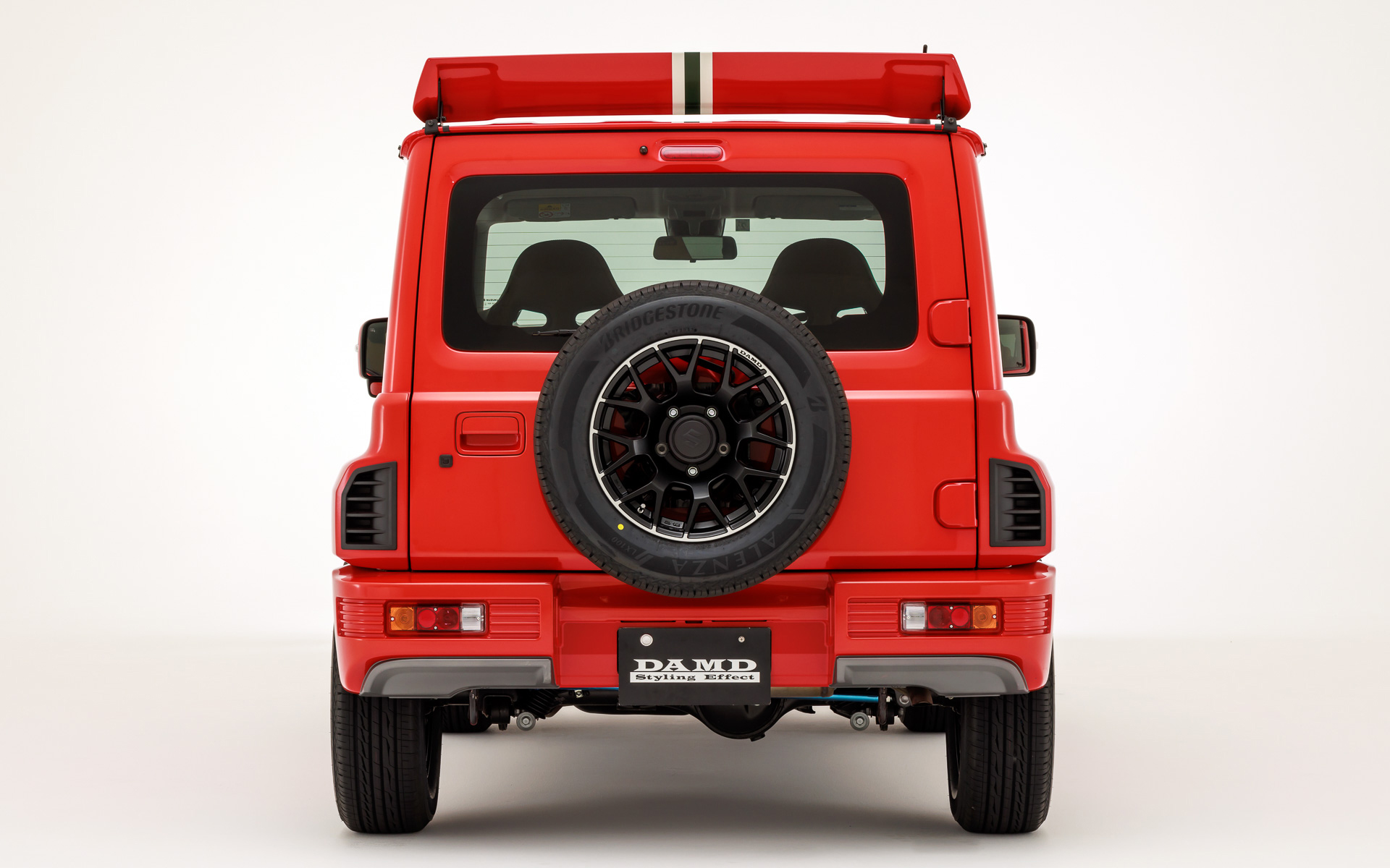 Rear view of a red Suzuki Jimny with a Lancia Delta Integrale bodykit