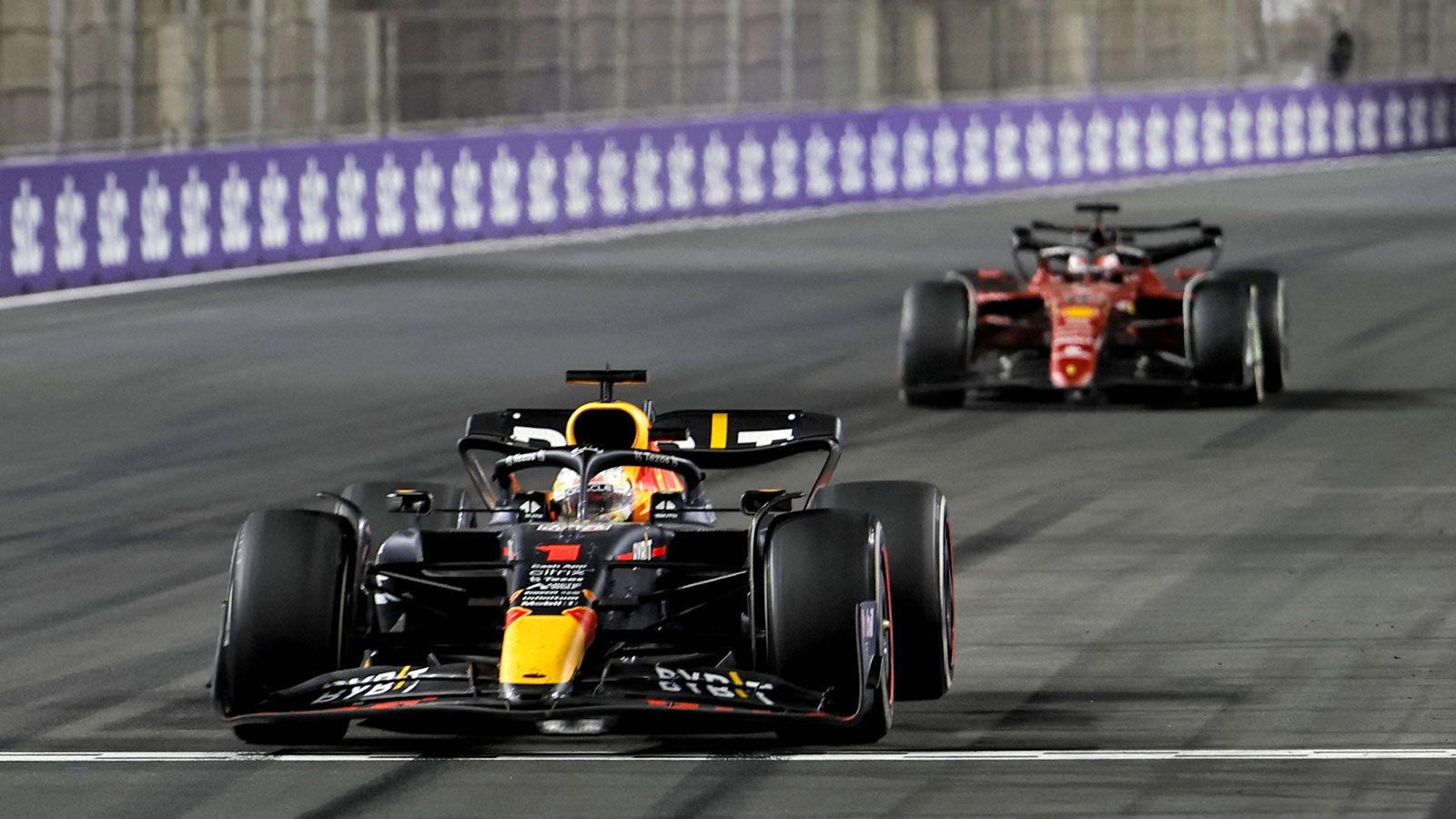 A photo of two F1 cars racing in Saudi Arabia. 