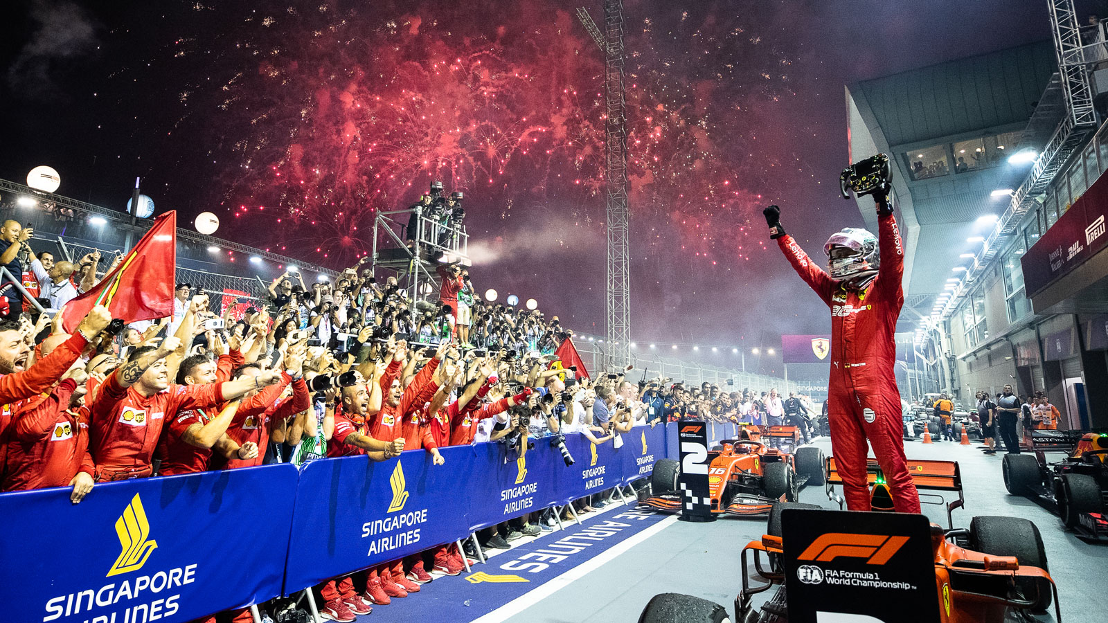 Sebastian Vettel stands on top of his Ferrari F1 car after winning the Singapore Grand Prix 