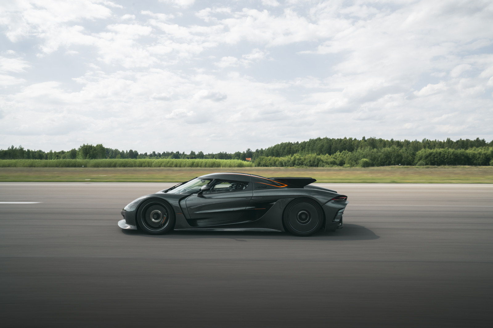 a photo of a Jesko hypercar driving on track. 