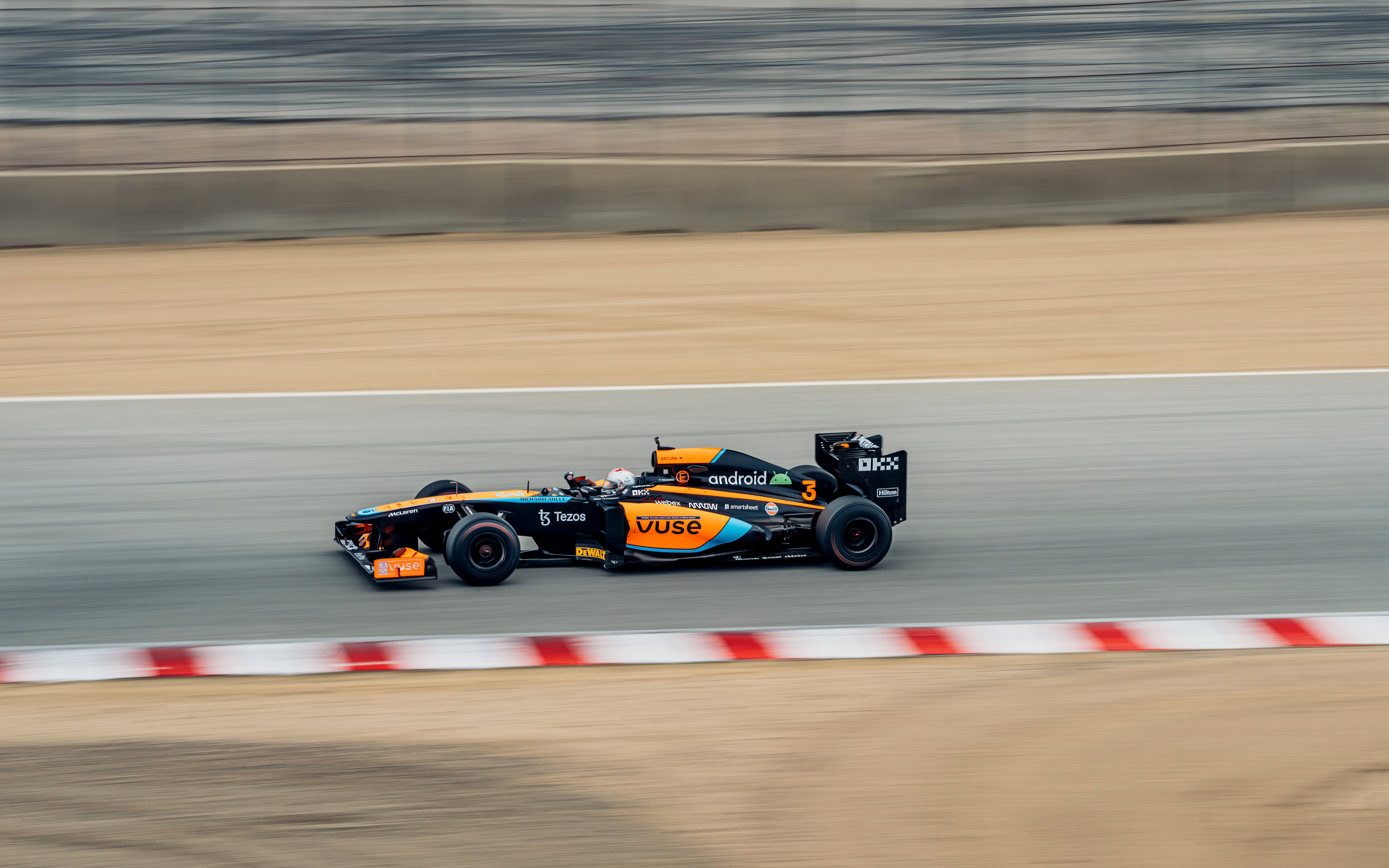 Mario Andretti pilots a modern F1 car around Laguna Seca.