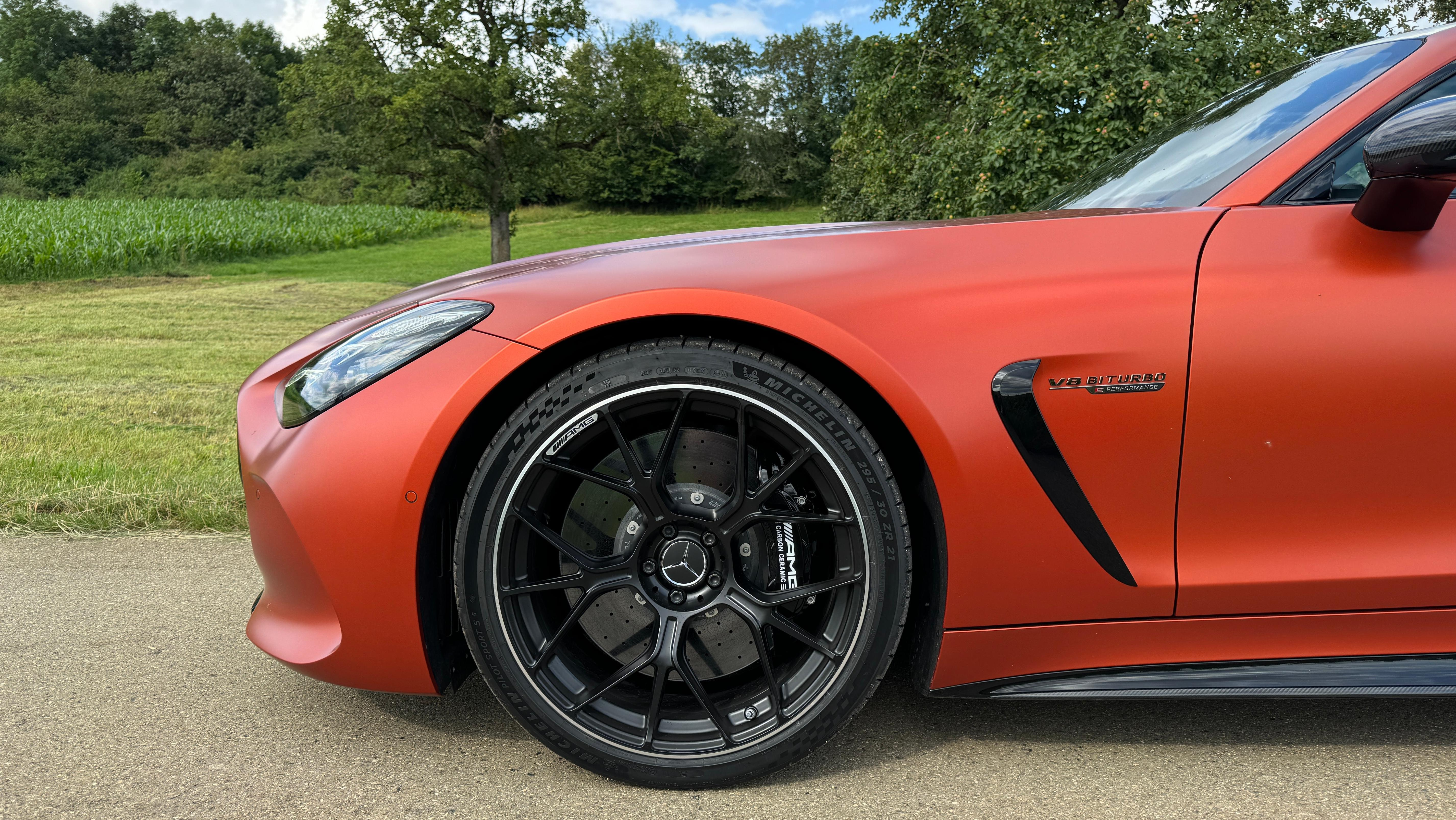 Front wheel of a matte orange 2025 Mercedes-AMG GT63 S E Performance