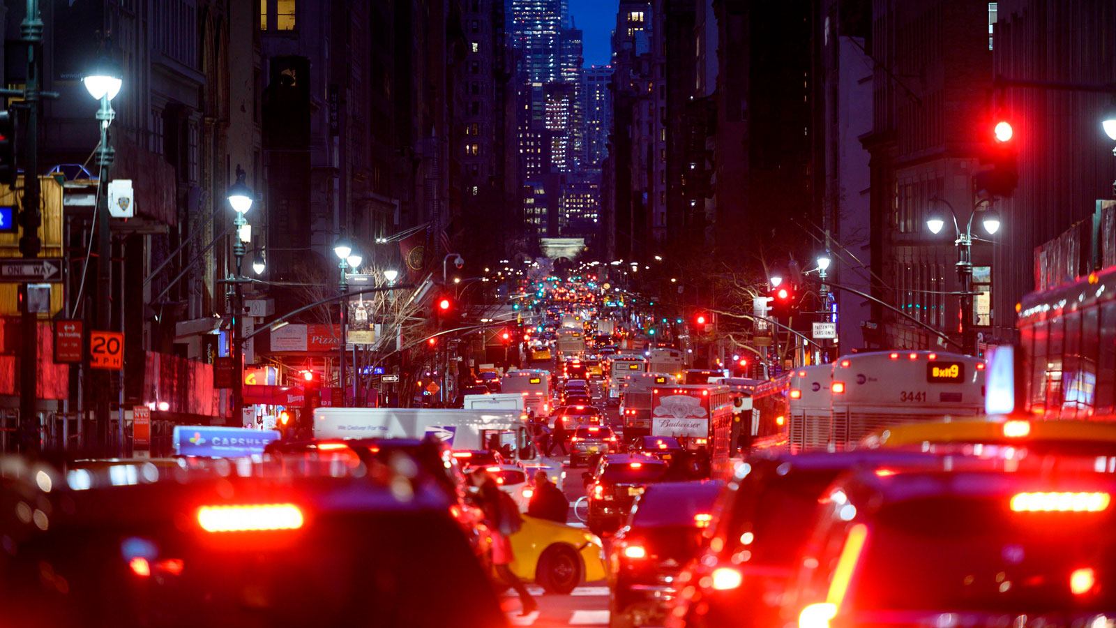 A photo of a busy street in New York at night. 