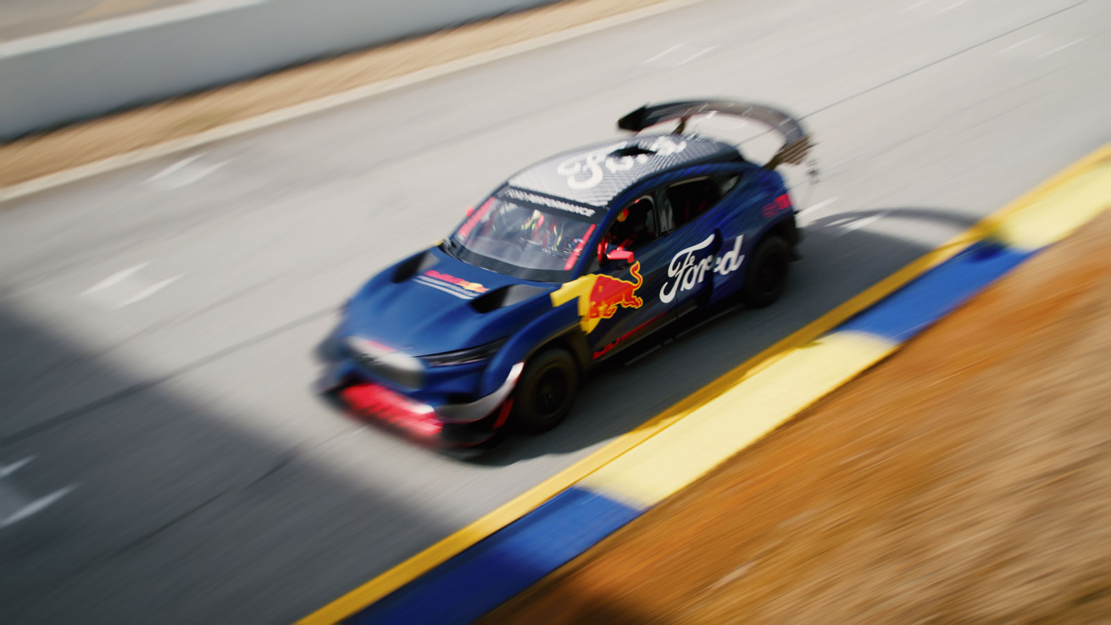 A photo of a Red Bull branded Ford Mustang Mach-E electric car. 