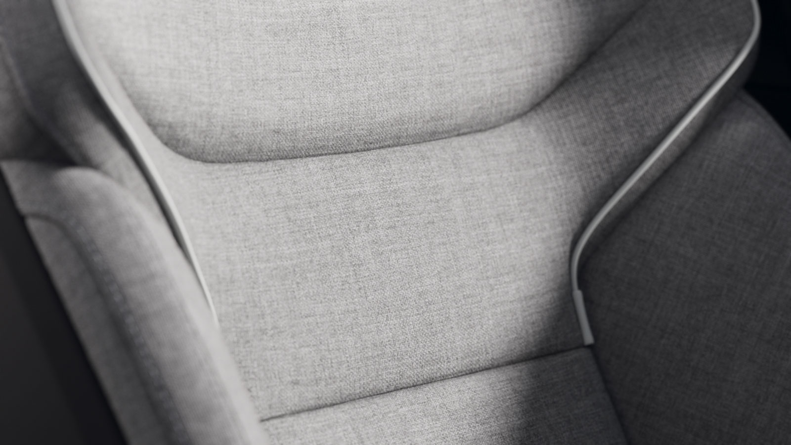 A close up photo of a Volvo seat covered in gray fabric. 