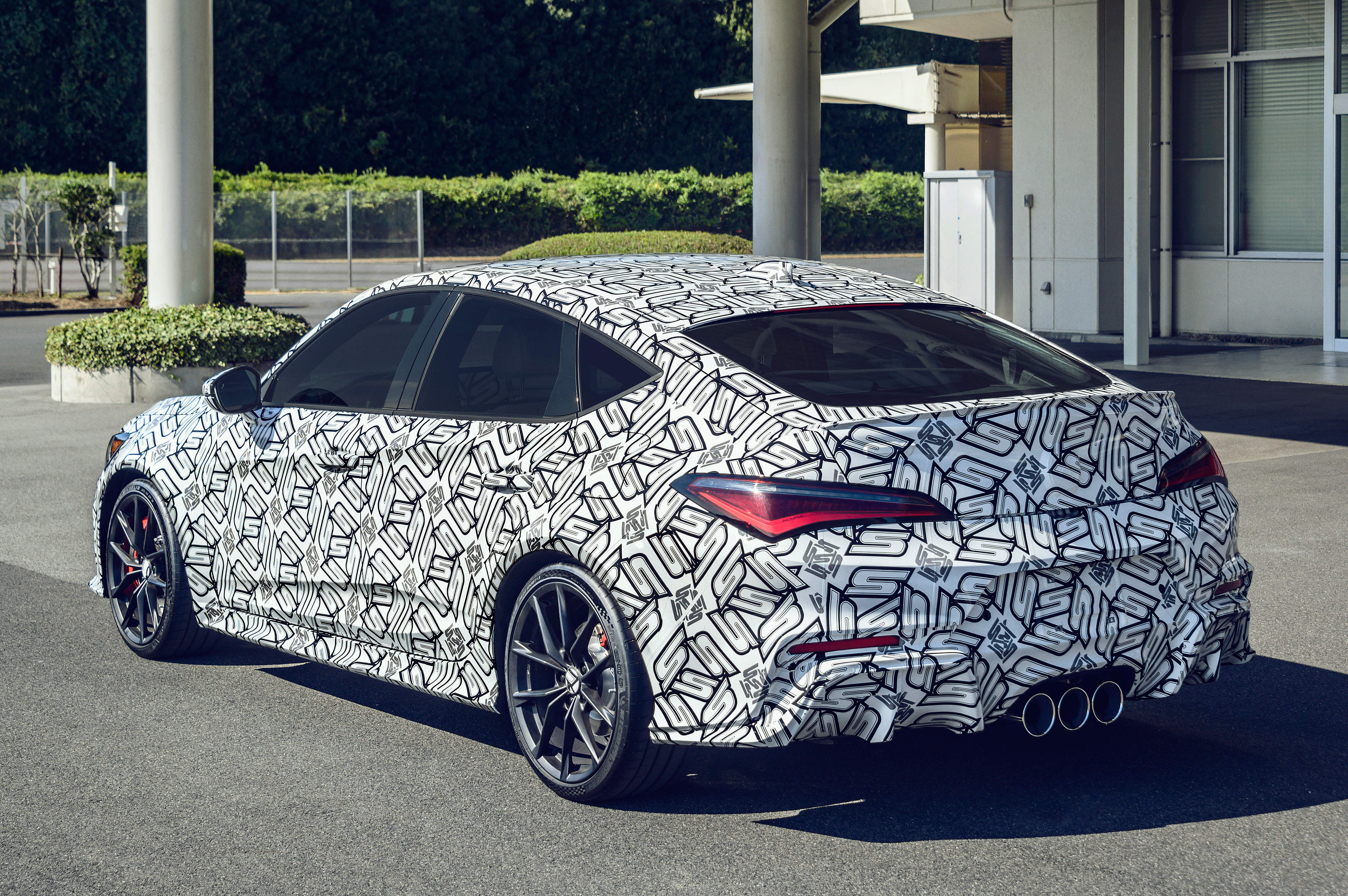 2024 acura integra type s prototype from the left rear 3/4 view, wrapped in black and white camouflage