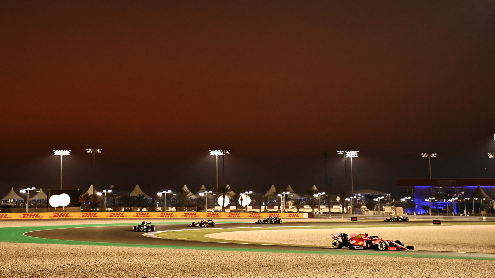 A photo of F1 cars racing in Qatar in 2021. 