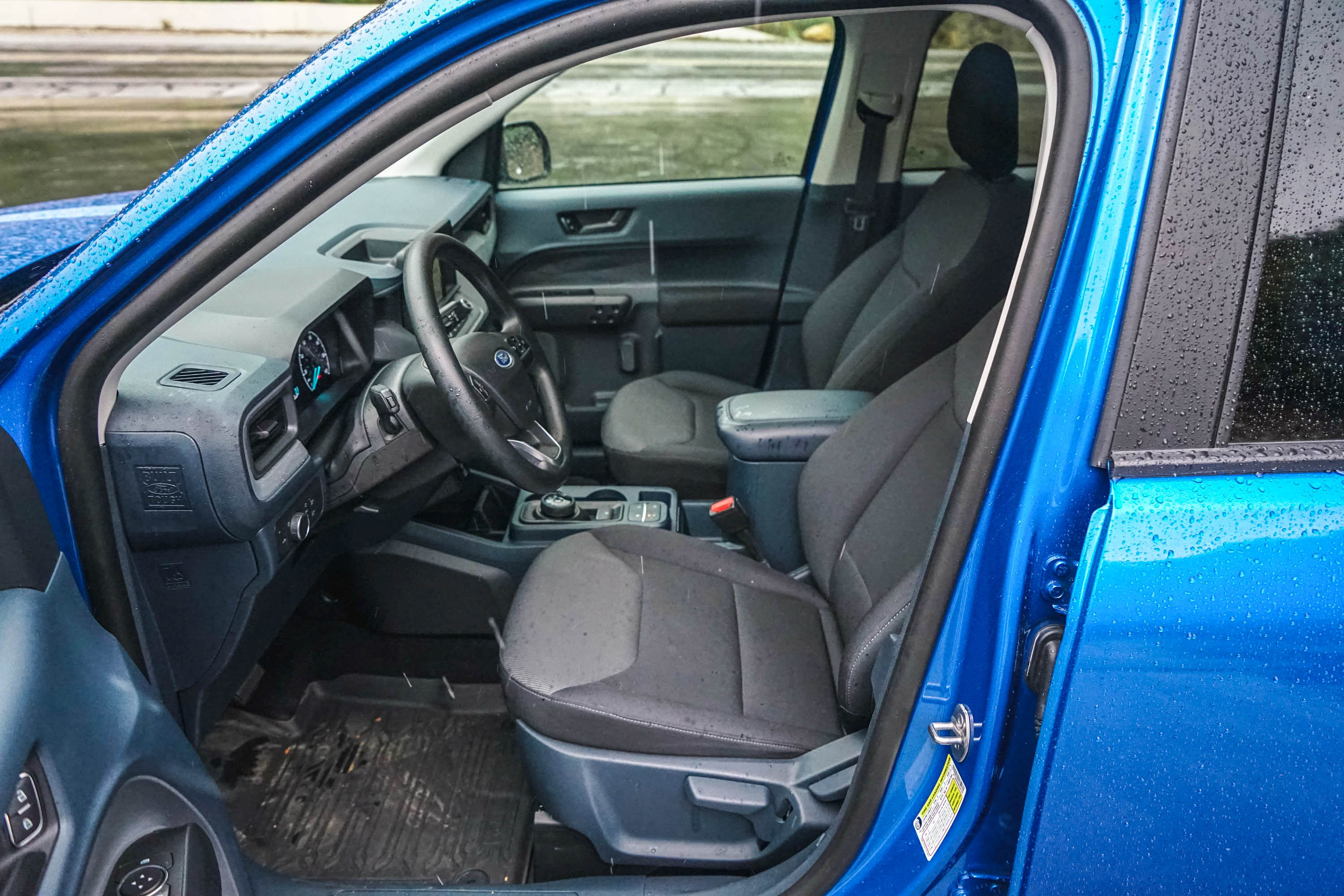 The view from the open driver's door on a 2023 Ford Maverick XL truck.