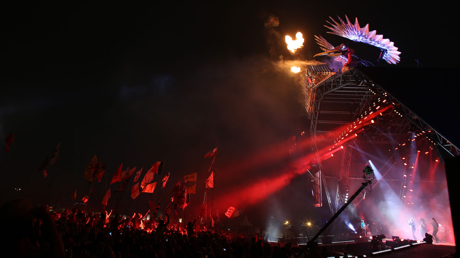 A photo of a mechanical phoenix on the top of the Pyramid Stage at Glastonbury Festival. 