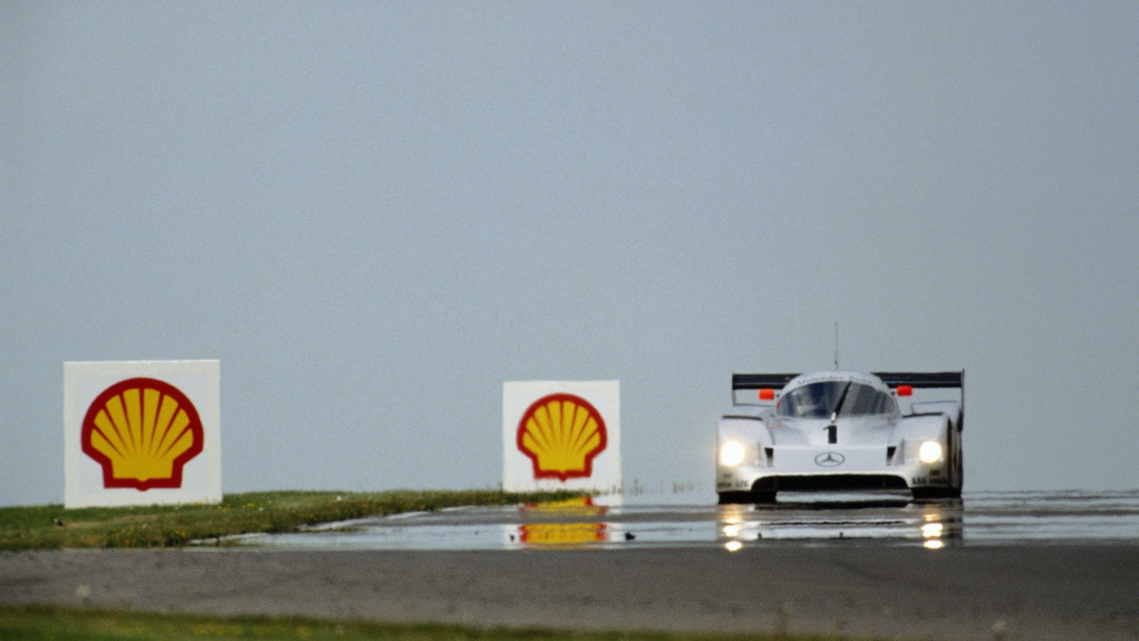 A photo of a Mercedes-Benz C11 on a race track. 