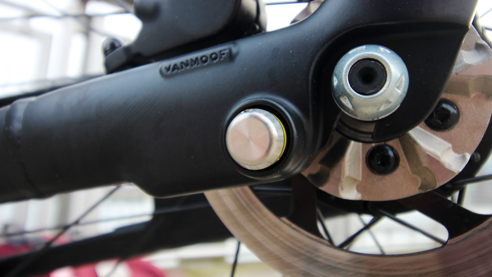 A close up photo of the kick lock and rear brakes on the VanMoof S3. 