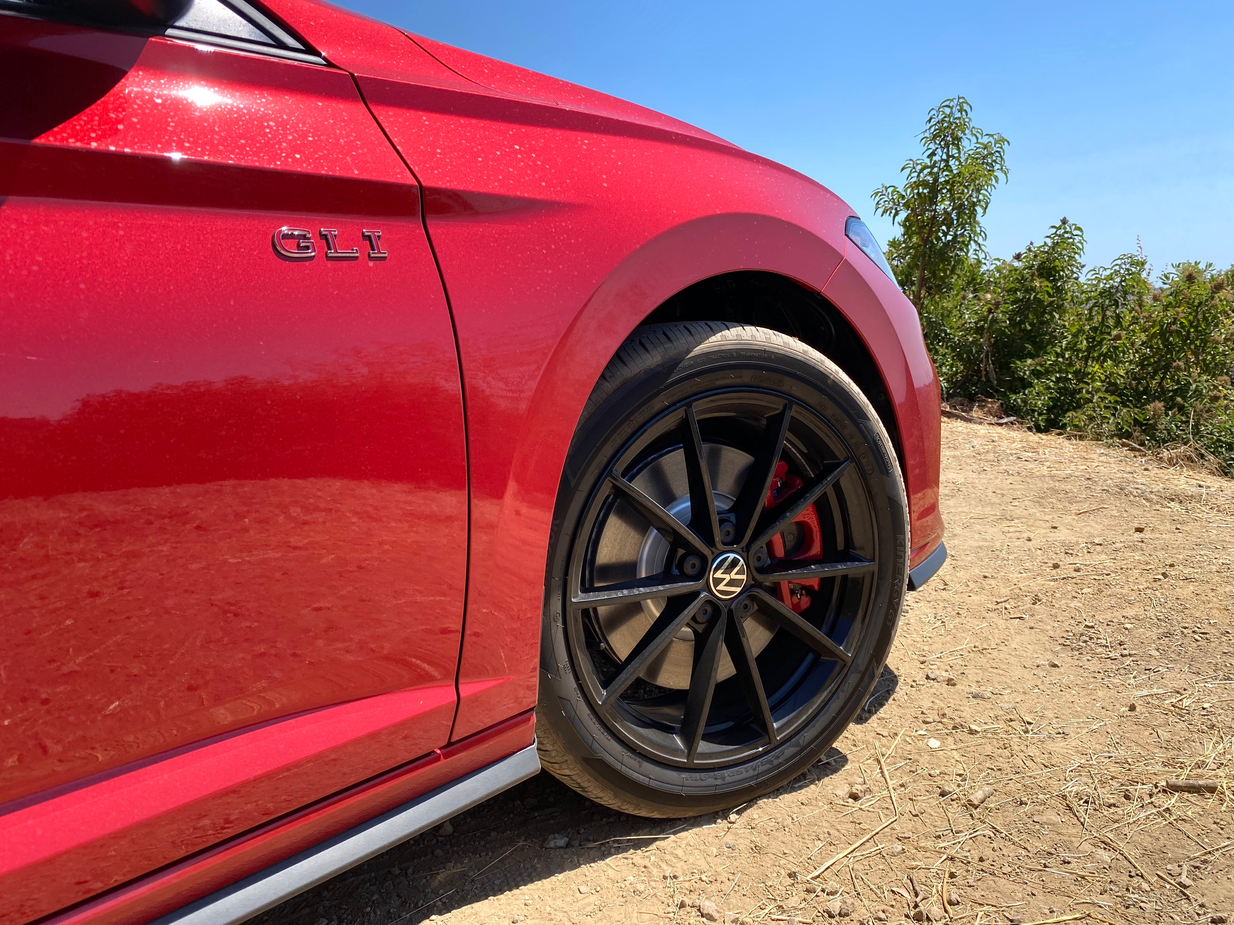 A close-up of the front passenger wheel and GLI badge