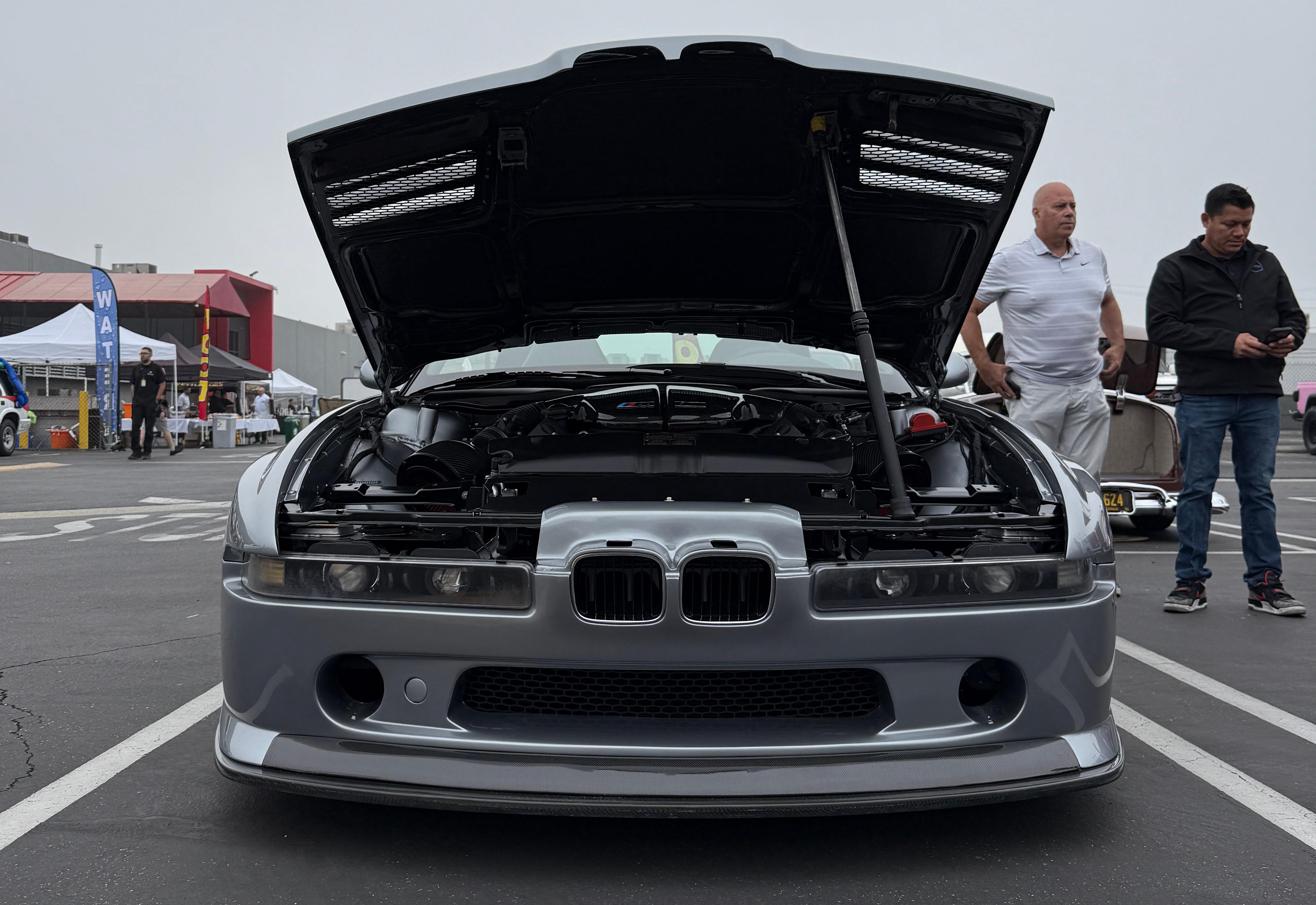 Front view of the silver BMW 858 CSL with the hood open