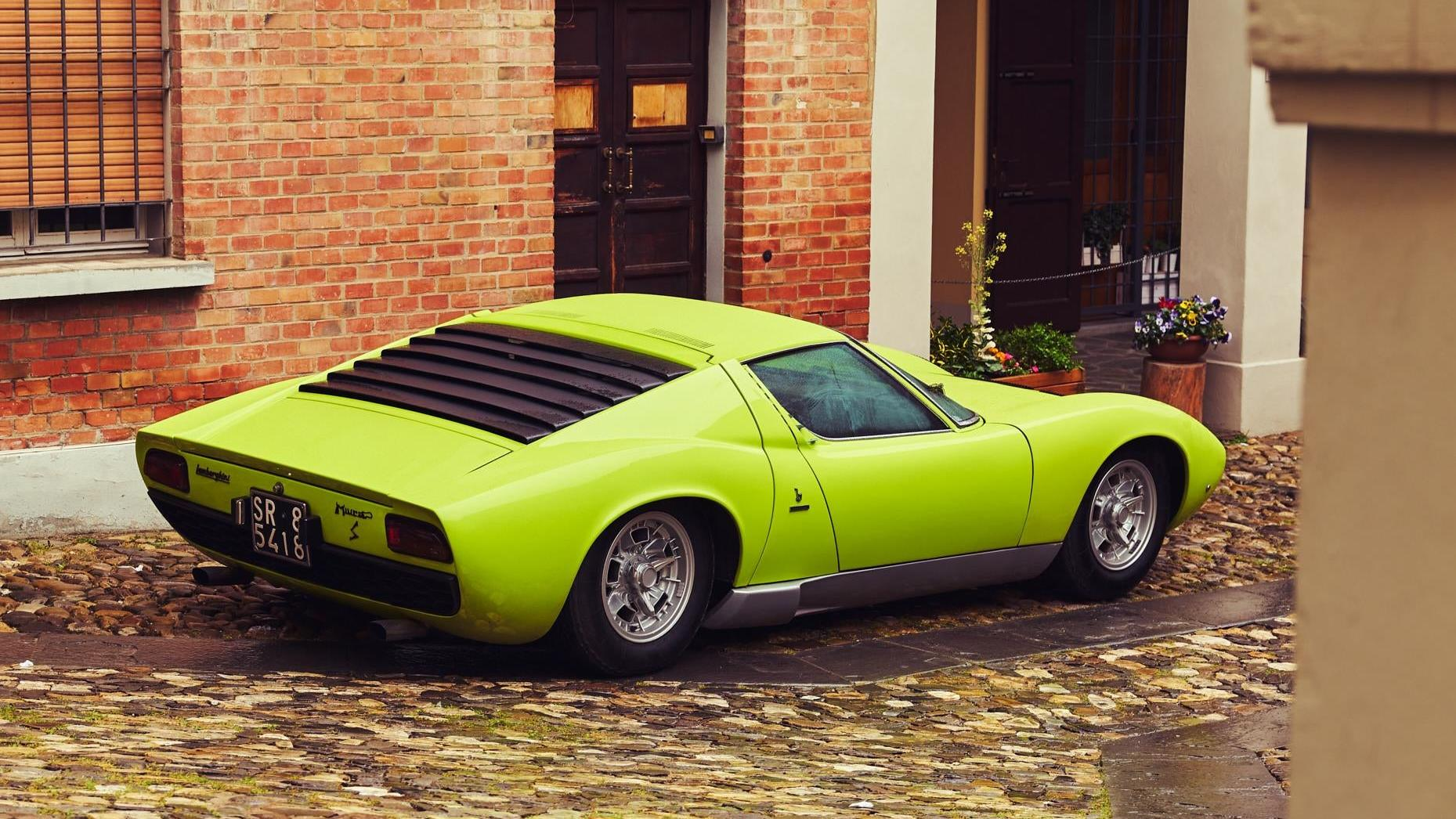 Rear 3/4 view of a lime green Lamborghini Miura