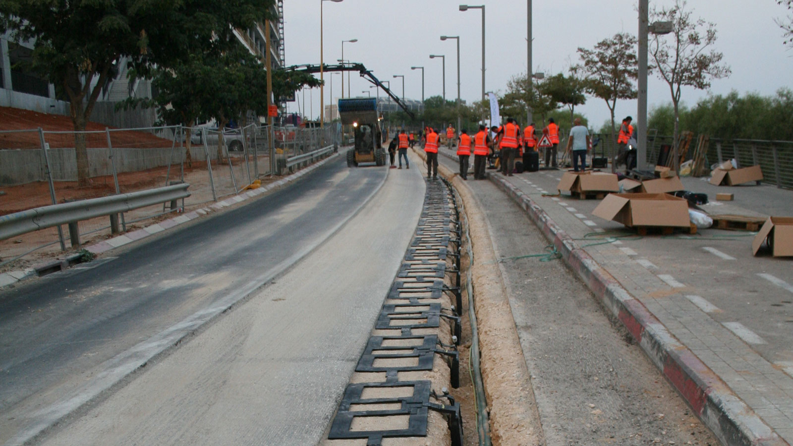 A photo of copper coils being installed underneath a road. 