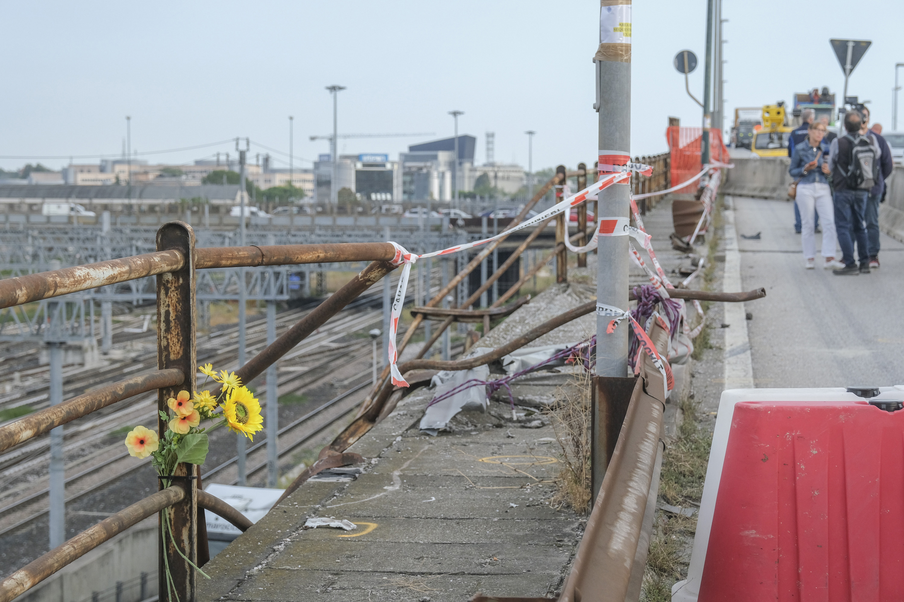 Bouquets of flowers are left near the crash site on October 04, 2023 in Venice, Italy. Venice prosecutors opened an investigation after a bus carrying foreign tourists on the outskirts of Venice crashed, killing 21 people.