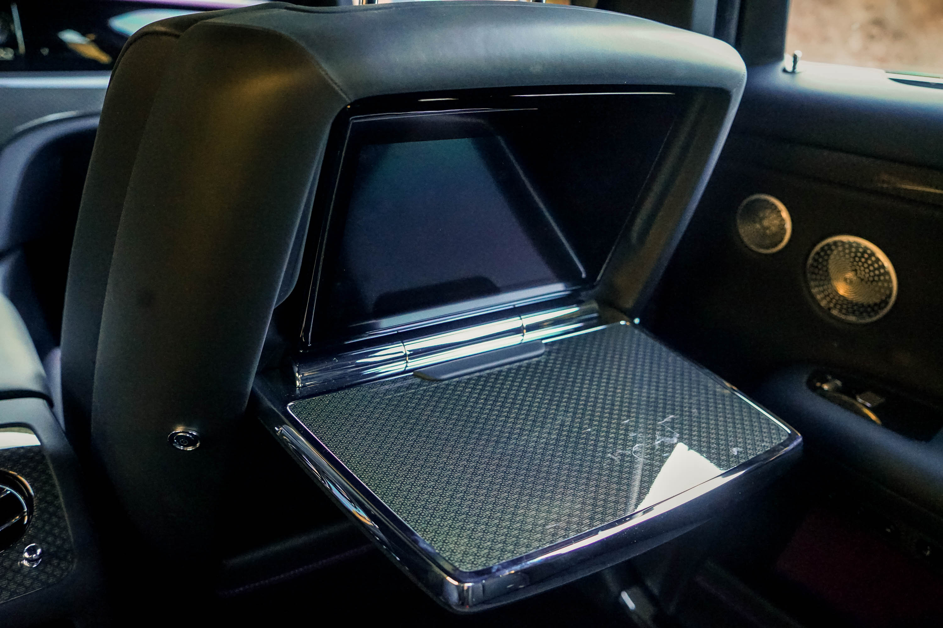 The fold-down rear table and screen of the 2023 Rolls-Royce Black Badge Ghost