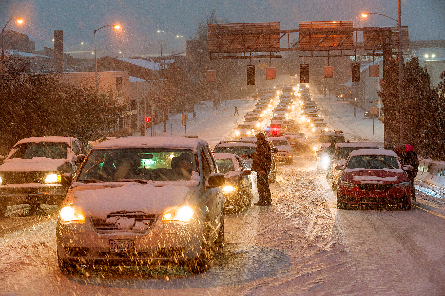 A line of cars, stuck in the snow