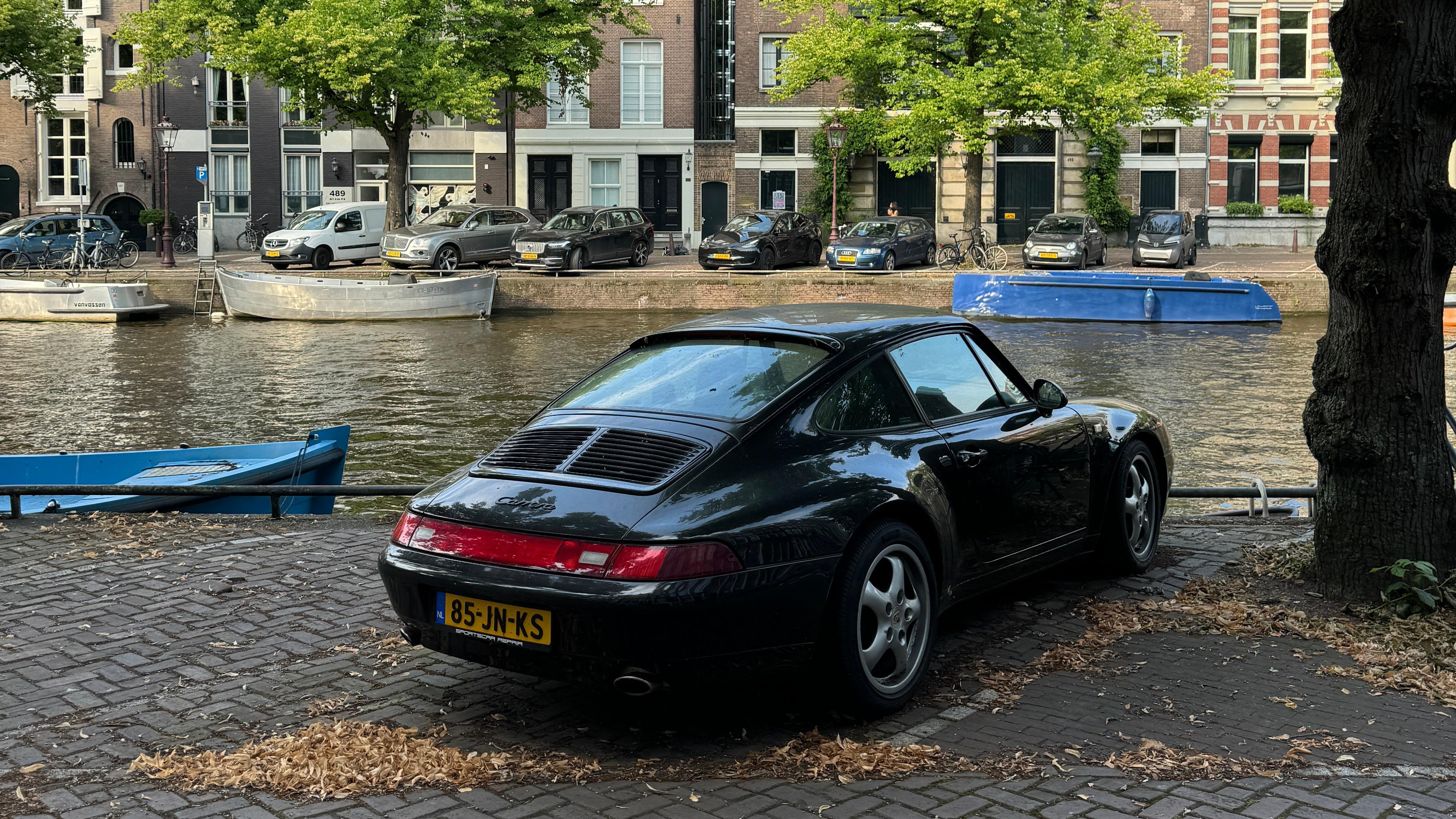 Rear 3/4 view of a black 993 Porsche 911