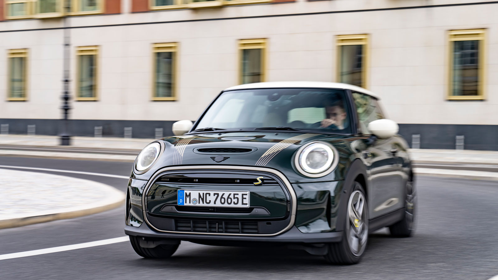 A photo of a dark green Mini Cooper SE electric car. 