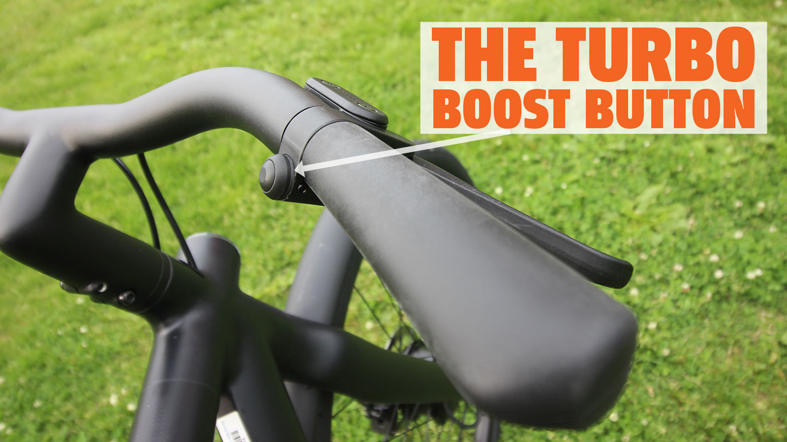 A photo of the VanMoof handlebars highlighting the Turbo Boost button on the right hand side. 