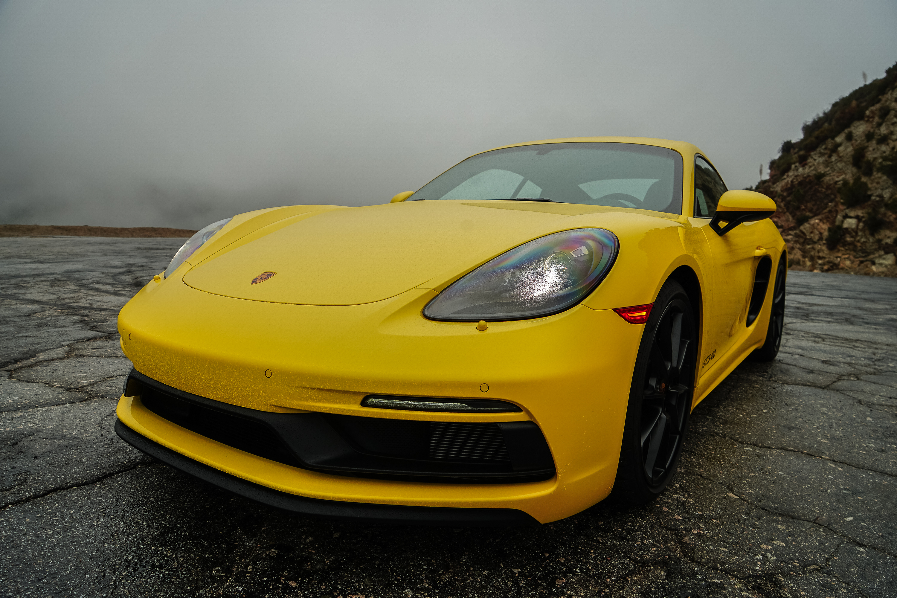 The front three-quarter view of a yellow 2022 Porsche Cayman GTS 4.0