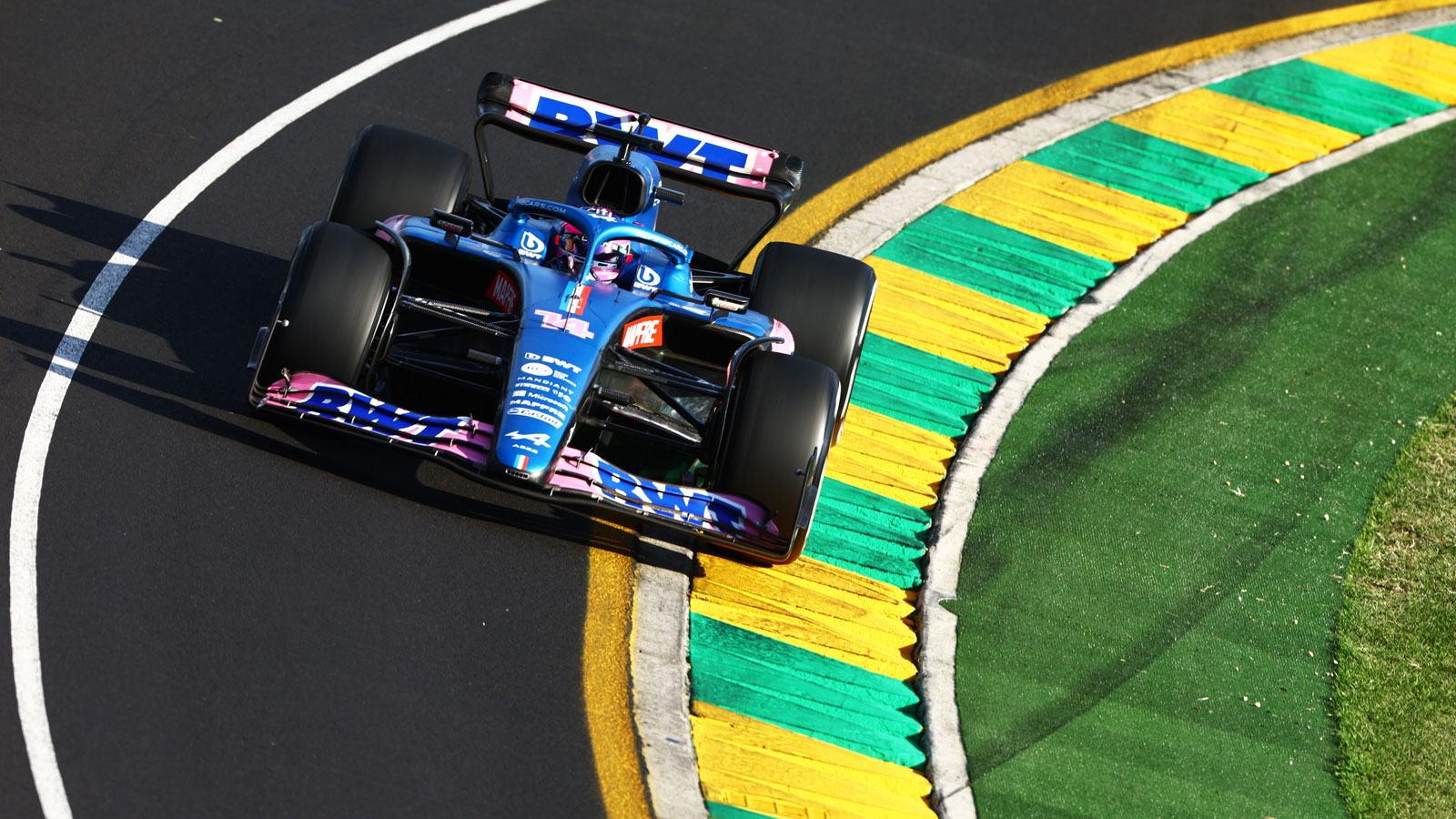 A photo of Fernando Alonso's F1 car rounding a corner in Australia